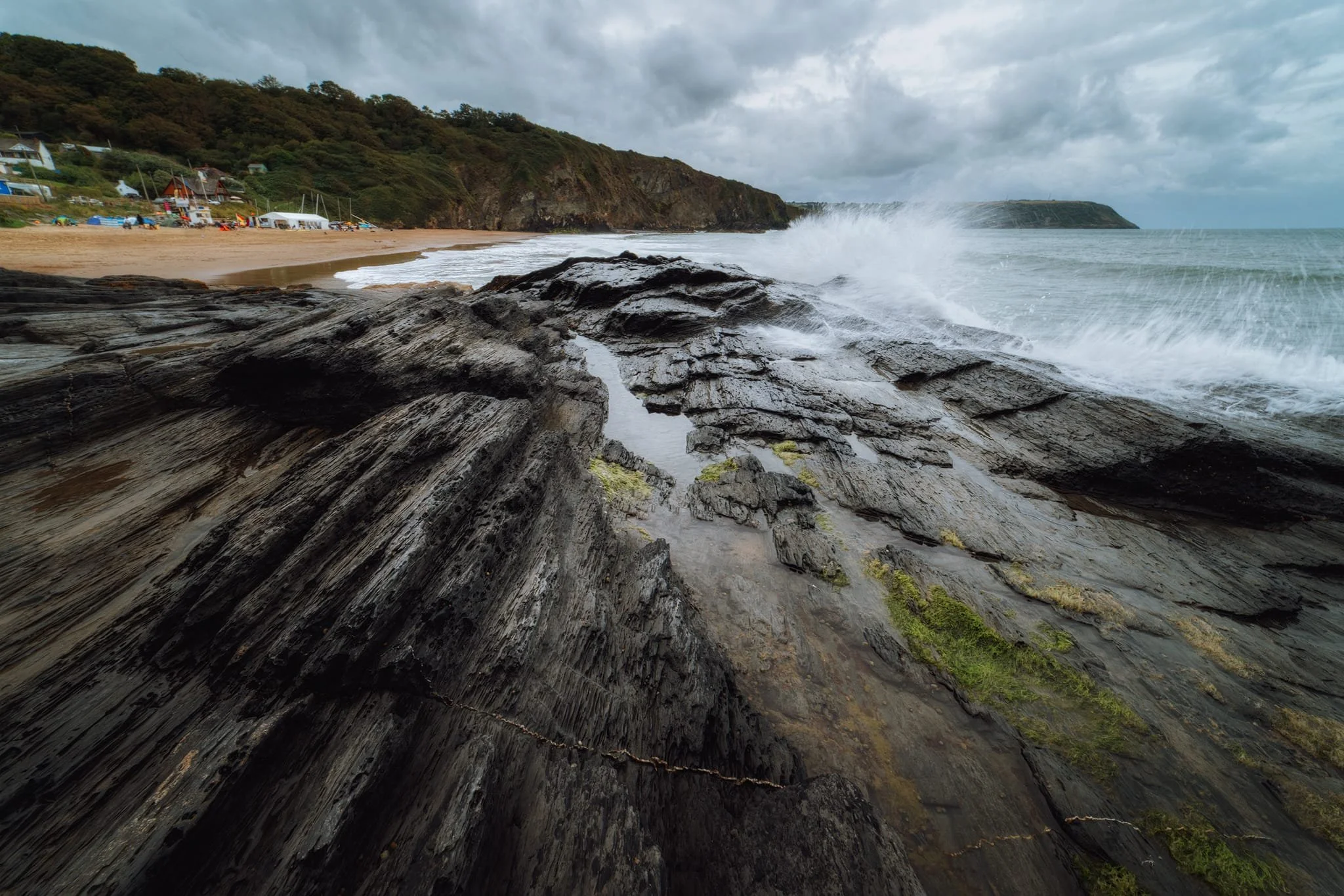  Facing the other direction, I sought out more interesting shapes, colours, and patterns in the local geology. I took a few turns on this composition, and as the Irish Sea was rushing in, I tried taking a few where the waves crashed against the raised crag I was on. This image was the best of the bunch. 