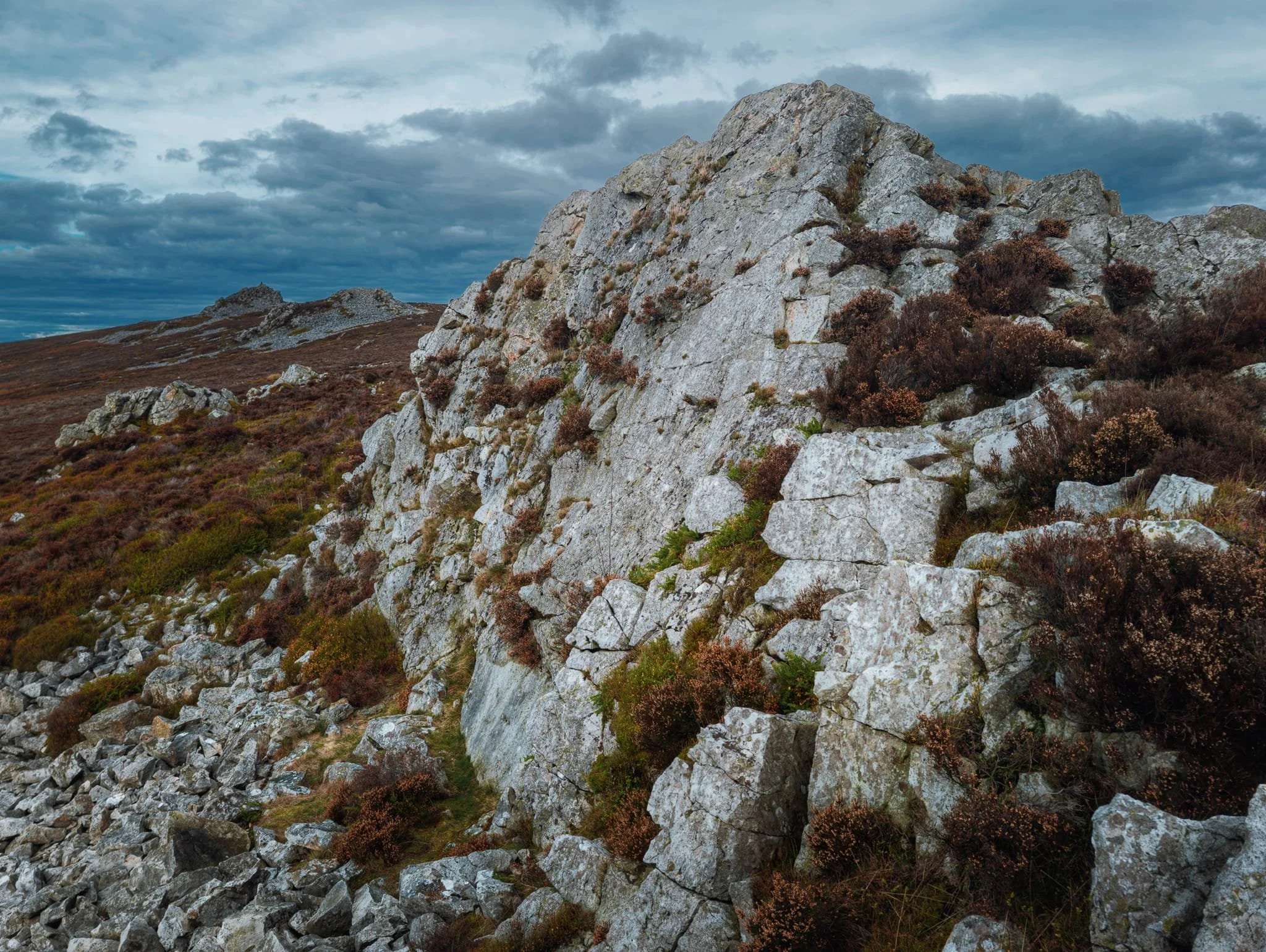  The Stiperstones is a hill as well as the collective names for all the rock formations along its summit. This is the western face of Cranberry Rock, with Manstone Rock then Devil&rsquo;s Chair in the distance. 