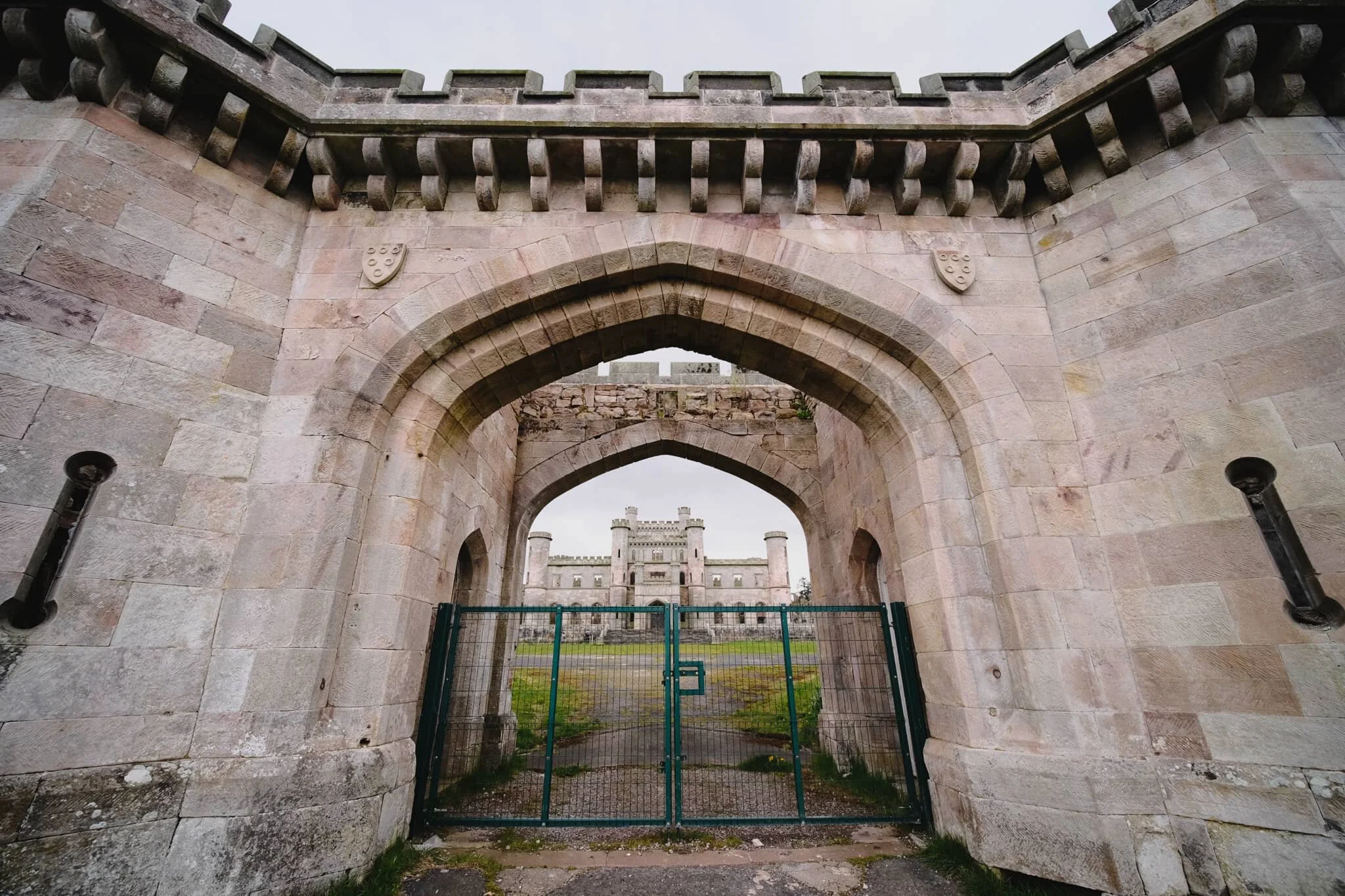Some of the gatehouses have been left alone, offering this interesting composition involving the castle ruins. Just a shame about the gate.