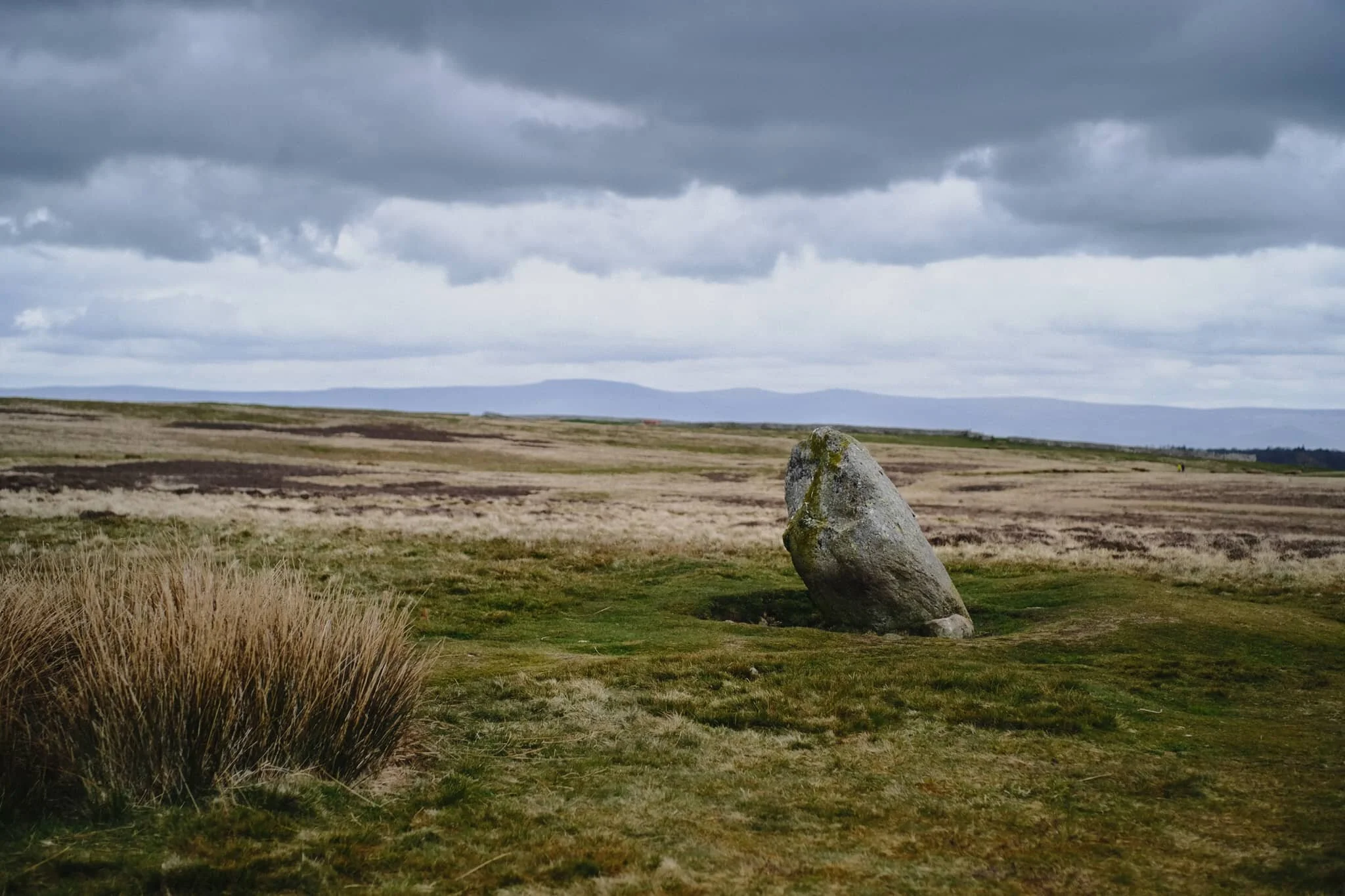 This is the Cop Stone, a standing stone located near the Moor Divock stone circle on Askham Fell. A prehistoric monument, it’s reason for being lost in time. In the distance is the unmistakeable wall of the Northern Pennines.