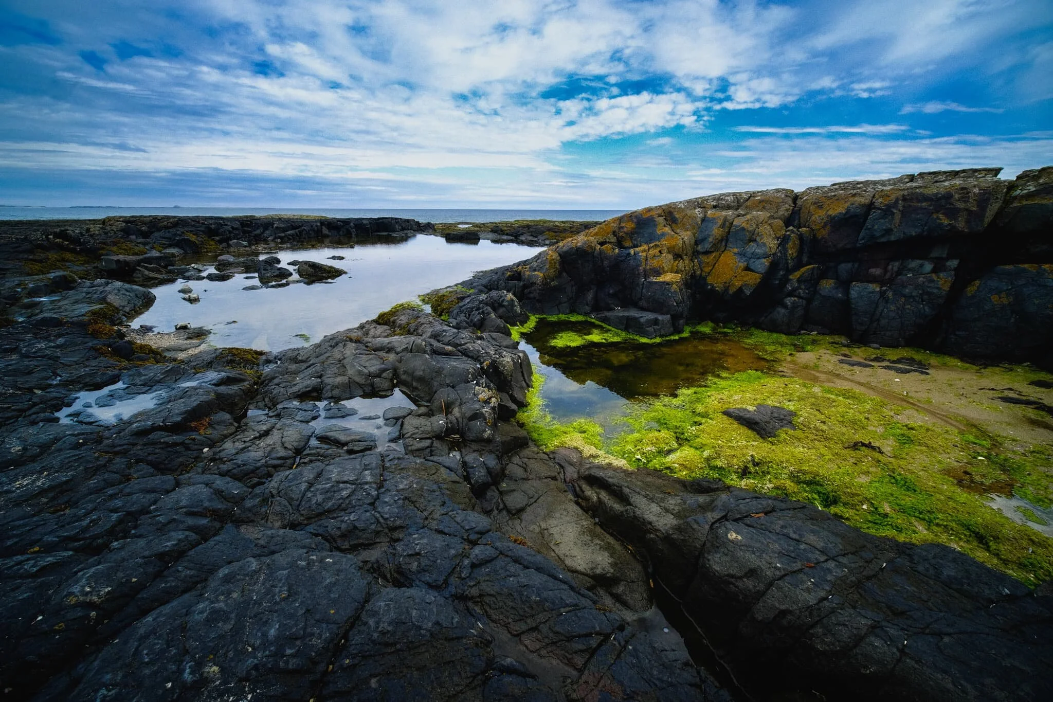Back from the main rock pool, I spotted another smaller rock pool filled with vivid lime green sea moss. I lined up a composition to create a kind of Figure-of-8 shape in the middle of the frame, surrounded by the dark volcanic rocks of Blackrocks Point.