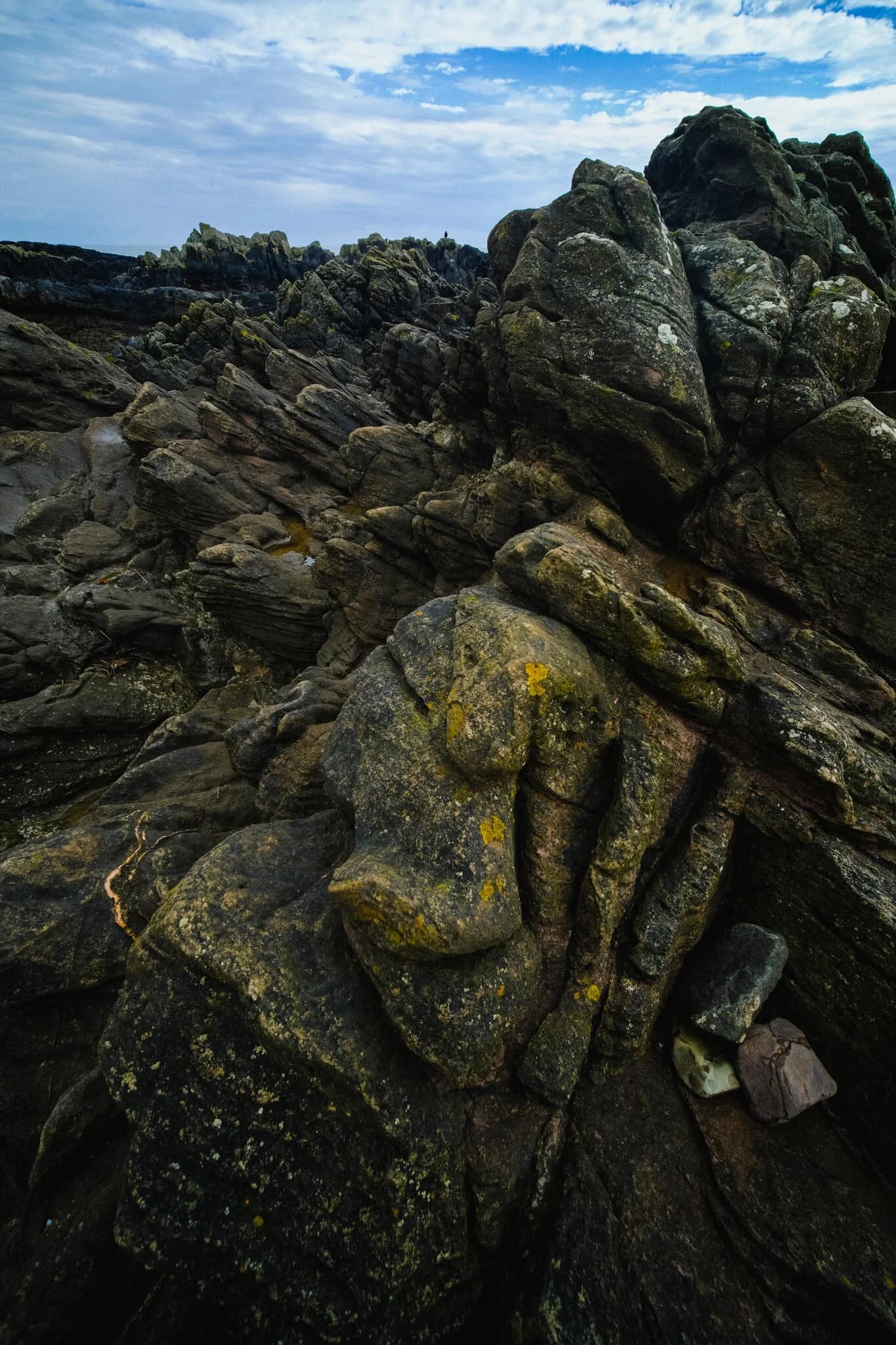 Harkess Rocks and Blackrock Point features a prehistoric fault line and a confusing jumbled mass of ancient volcanic rock. Compositionally, I think this area is better to shoot when the tide is in, allowing the water to better separate the shapes of the rocks.
