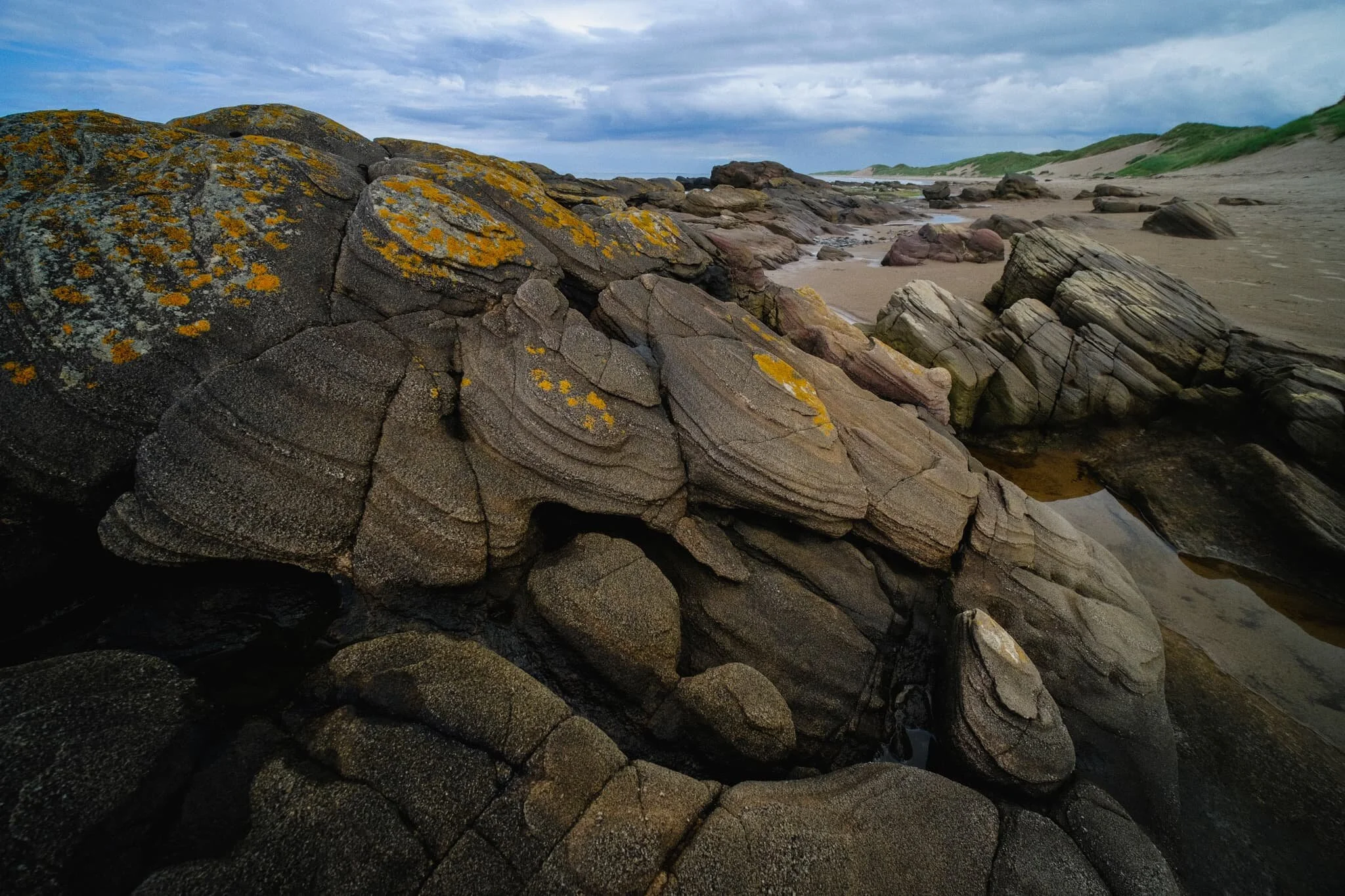 Another fantastical rock formation, seemingly made of “scales” of discs folding over each other.