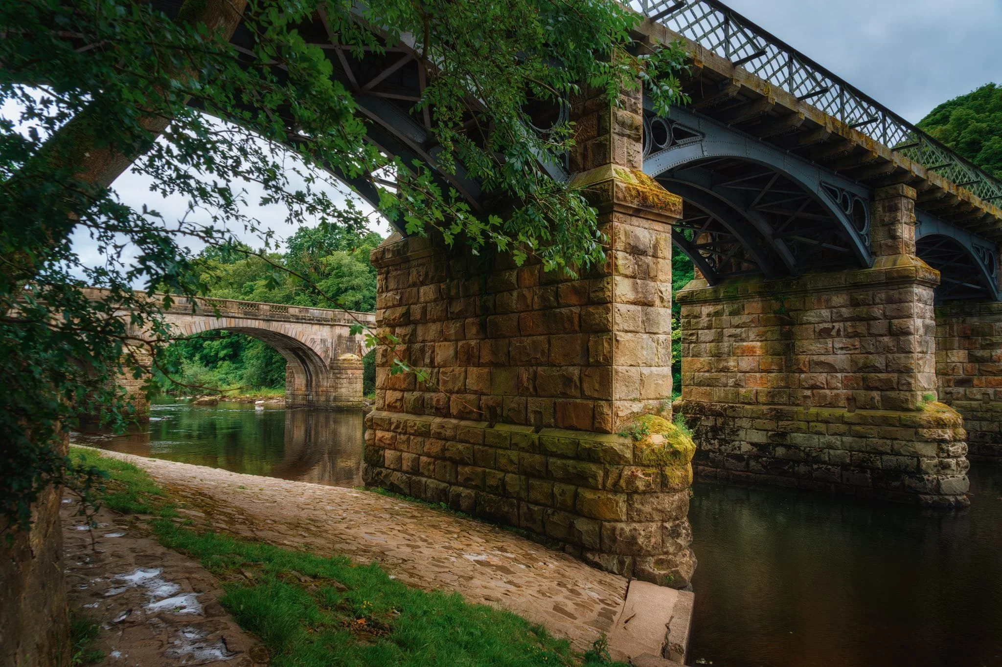  At my lens&rsquo; widest point of 24mm, I was able to capture both the Eastern Viaduct and the Caton Lune Bridge. The East Viaduct has five spans and was built in 1849 to carry the &ldquo;Little&rdquo; North Western Railway over the river. Like I mentioned earlier, the railway line was fully closed by 1967 and has since been converted into a footpath and cycleway. It underwent major repair and refurbishment in 2013.  