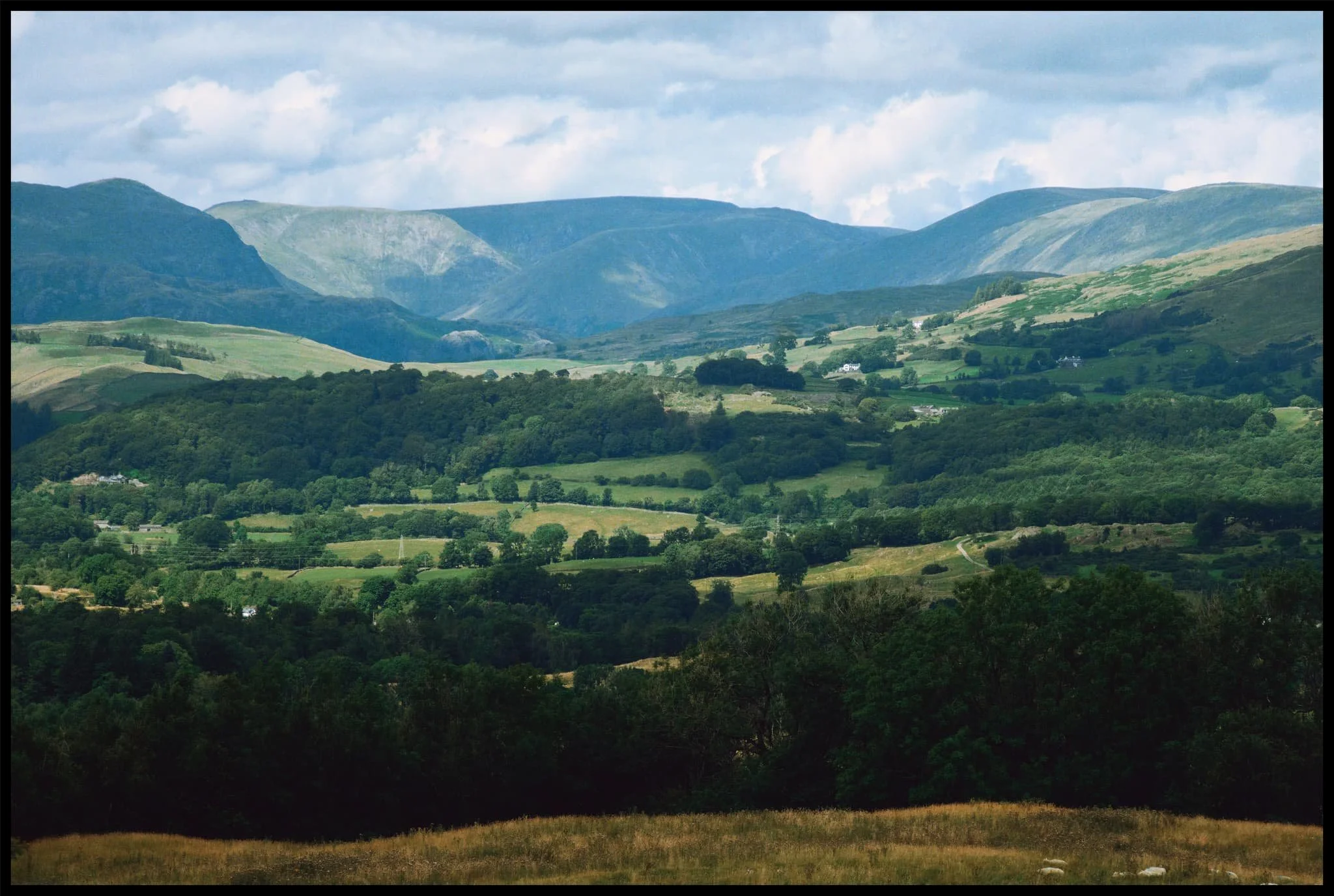  A zoomed in composition shows off the Kentmere fells with light and shadow dancing across their features. 