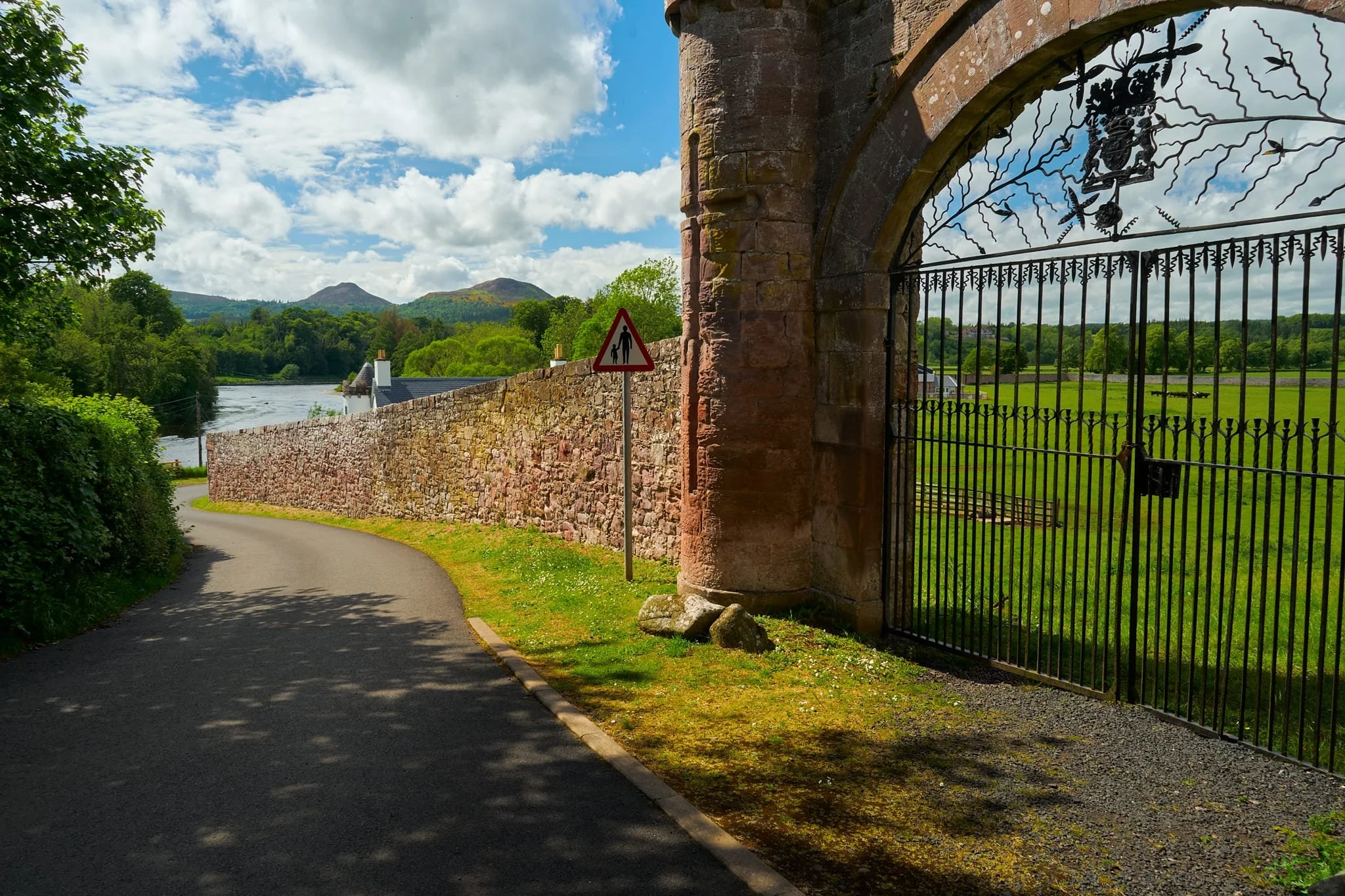  It&rsquo;s a simple affair to find the abbey after crossing the Tweed; follow the main road. As we did so, we found this rather ornate gate and wall, defining the grounds of the estate. There&rsquo;s a Latin inscription just out of shot above this gate: HOCPOMARIUM SUA MANUSATUM PARENTIBUS SUIS OPTIMIS SAC.D.S. BUCHANIA COMES. This roughly translates as, &ldquo;This orchard, planted with his own hand, is dedicated to his most excellent parents by D.S., Earl of Buchan.&rdquo; 