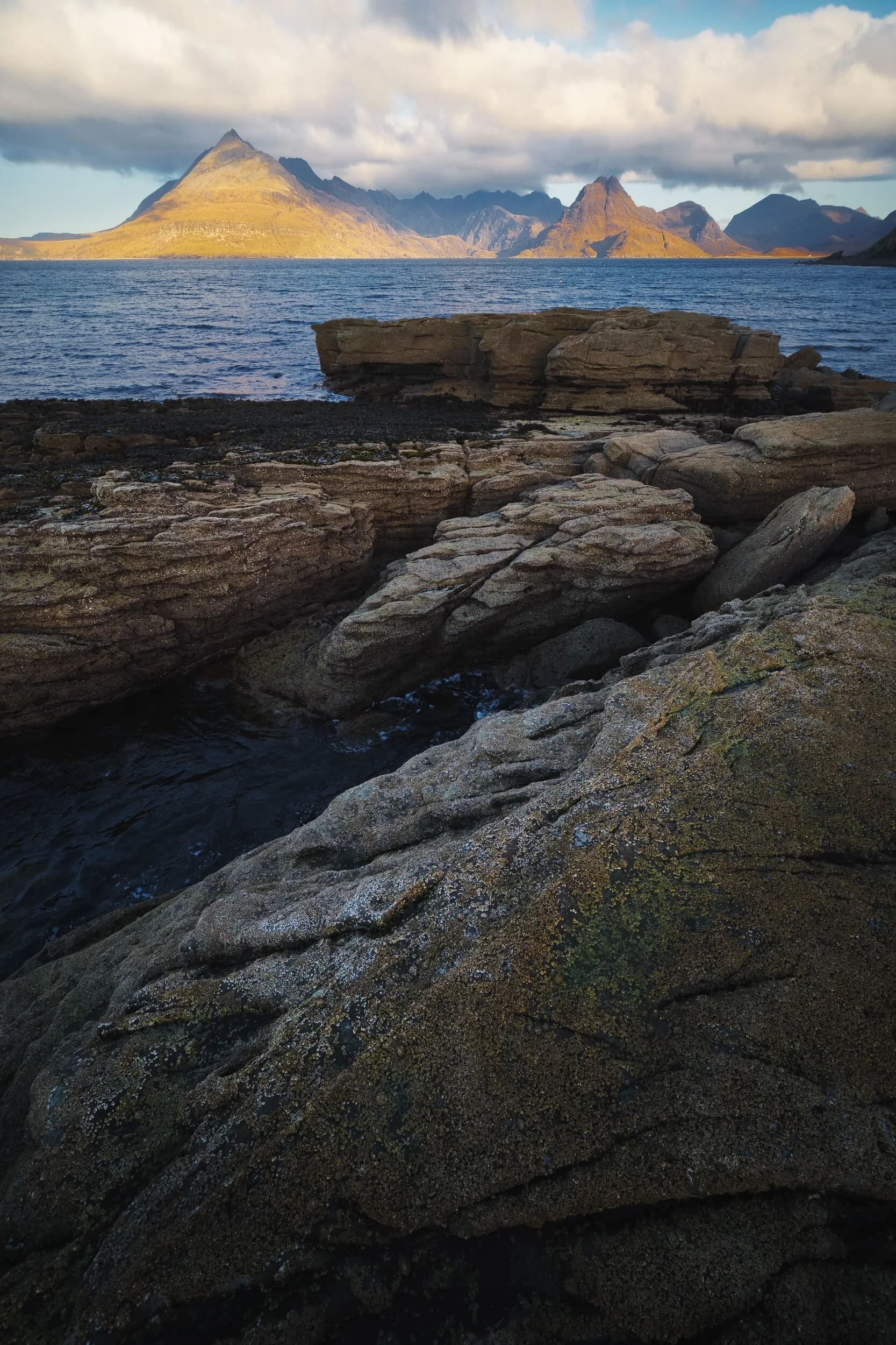  More light started to hit the Black Cuillins as I took this composition, with the sea intruding and cutting a channel into the raised platforms. 