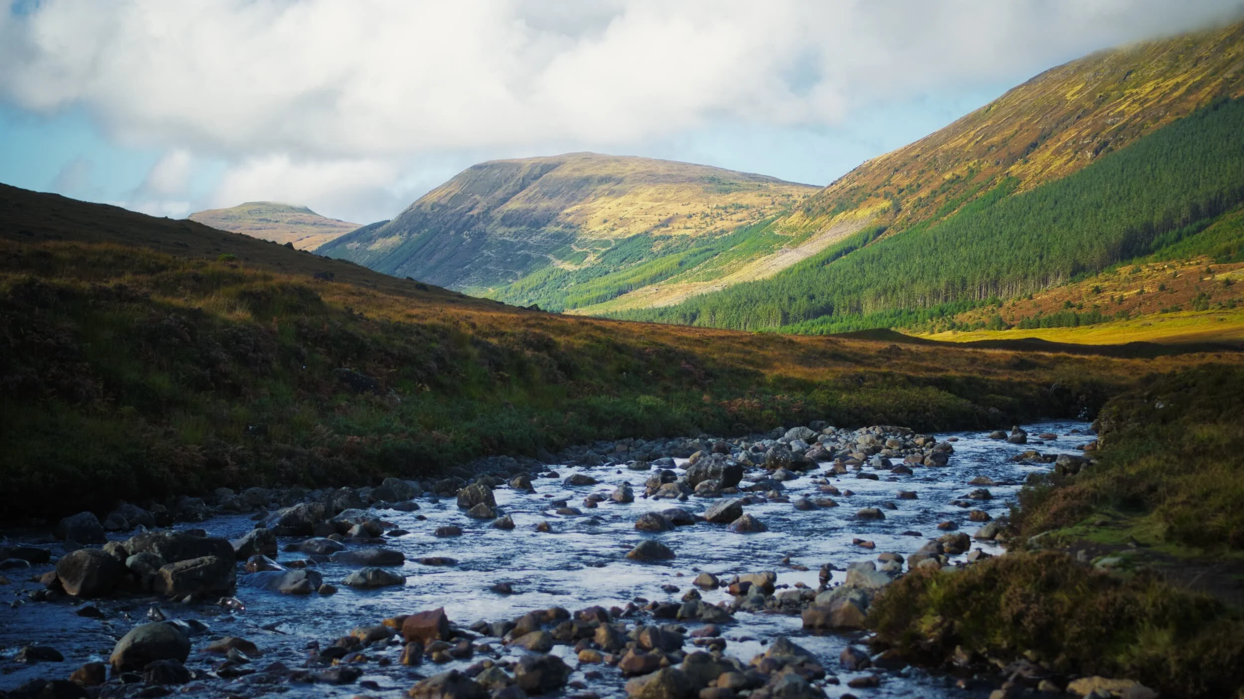  The hills that form the western side of the Glen Brittle valley, catching the post-sunrise light. Right to left:  Beinn a&rsquo; Bhràghad  (459 m/1,505 ft),  Beinn Staic  (412 m/1,351 ft), and  An Cruachan  (435 m/1,427 ft). 