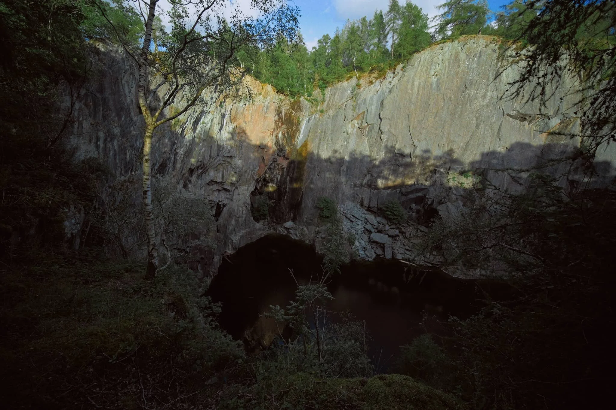  Thankfully, with my 9mm ultra-wide lens at hand, I was able to capture immense compositions that could feature  both  the dark pool and the sheer walls of the quarry, all at once. 