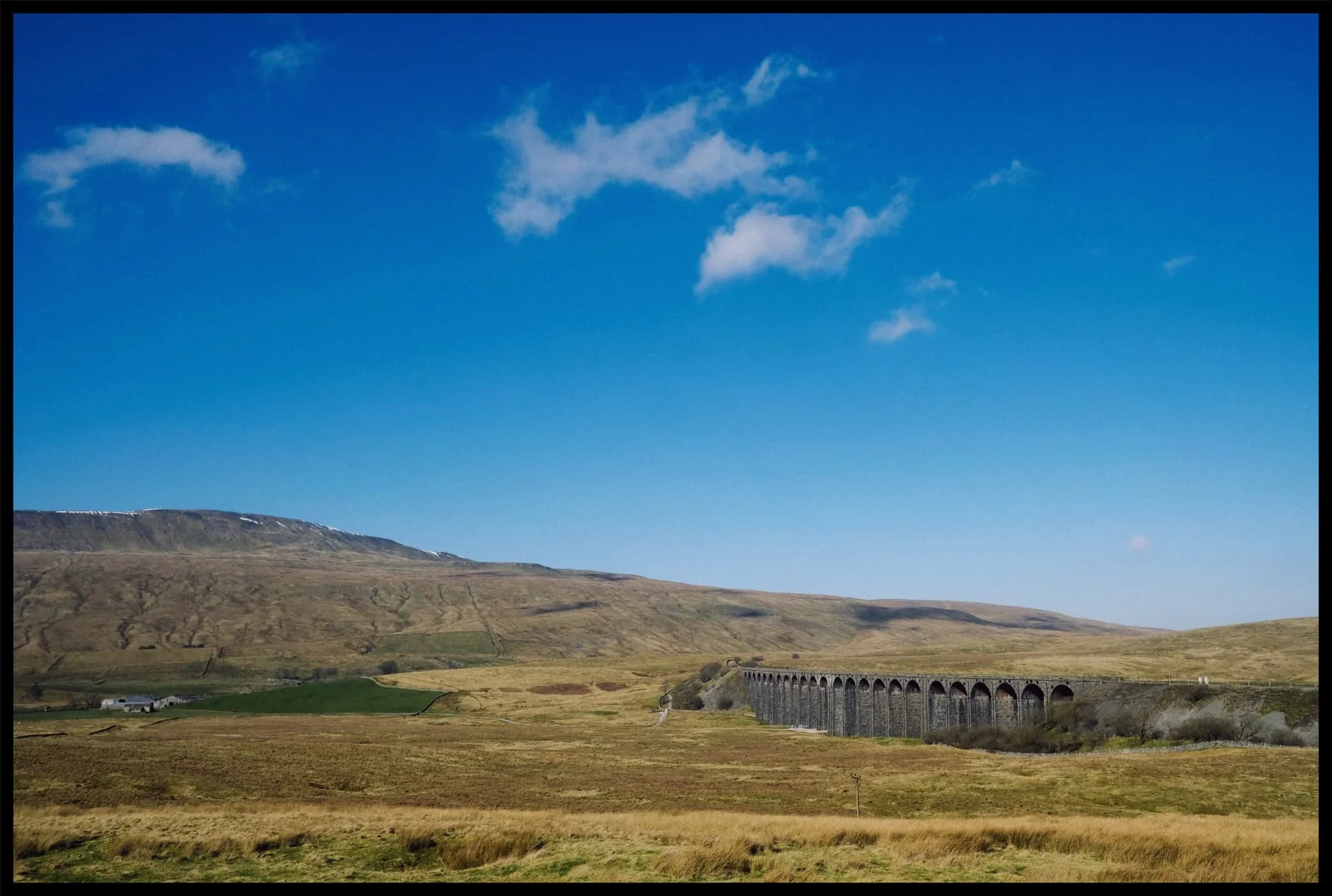  The area around the Ribblehead Viaduct was jammed with cars. Thankfully, we managed to find a small space to park up and snap some photos of this incredible architectural feat, situated underneath the highest peak of the Yorkshire Dales, Whernside. 