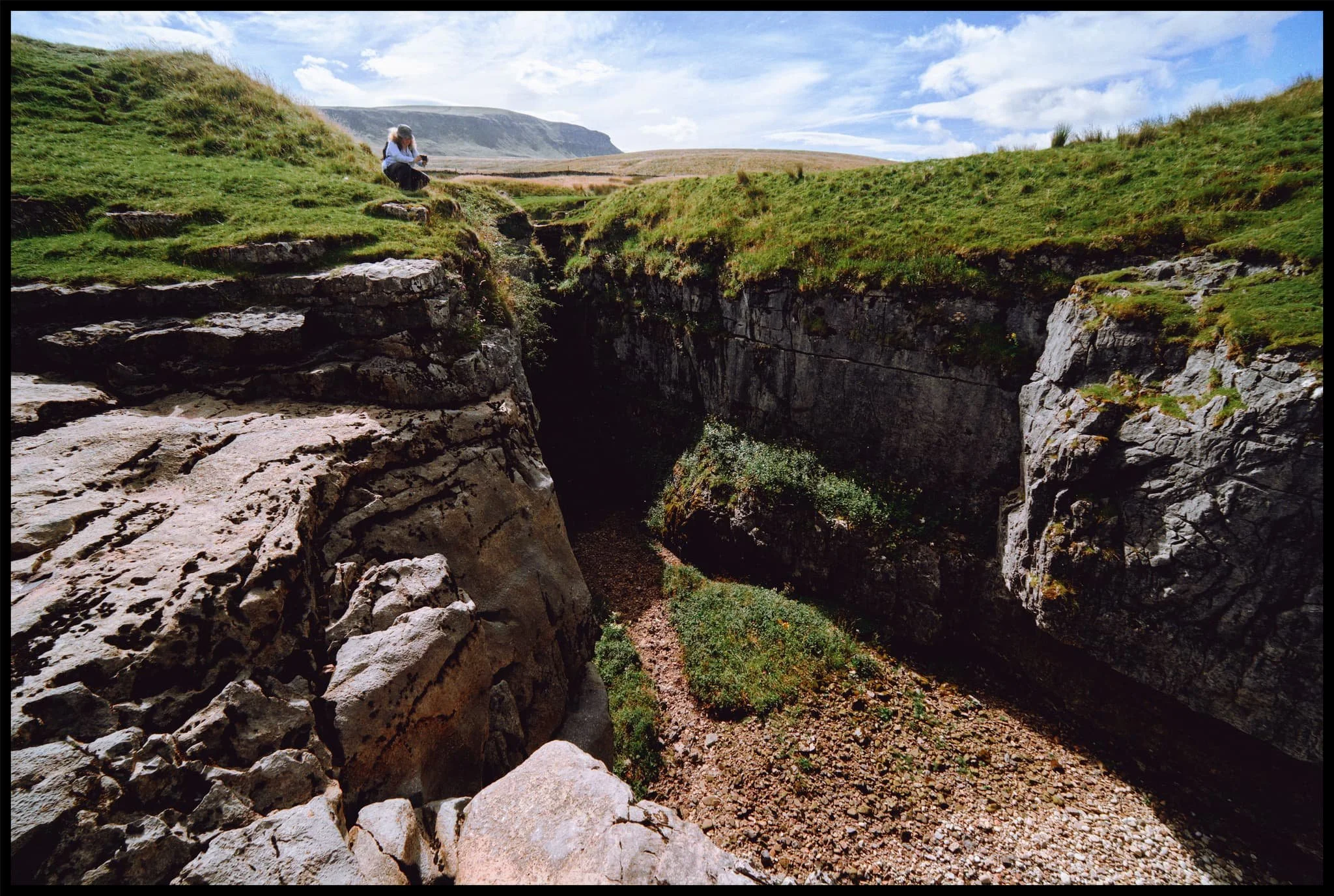  Lisabet and I played around the edge of the &ldquo;waterfall&rdquo; and Hull Pot, finding compositions. In the distance is Pen-y-Ghent, always watching. 
