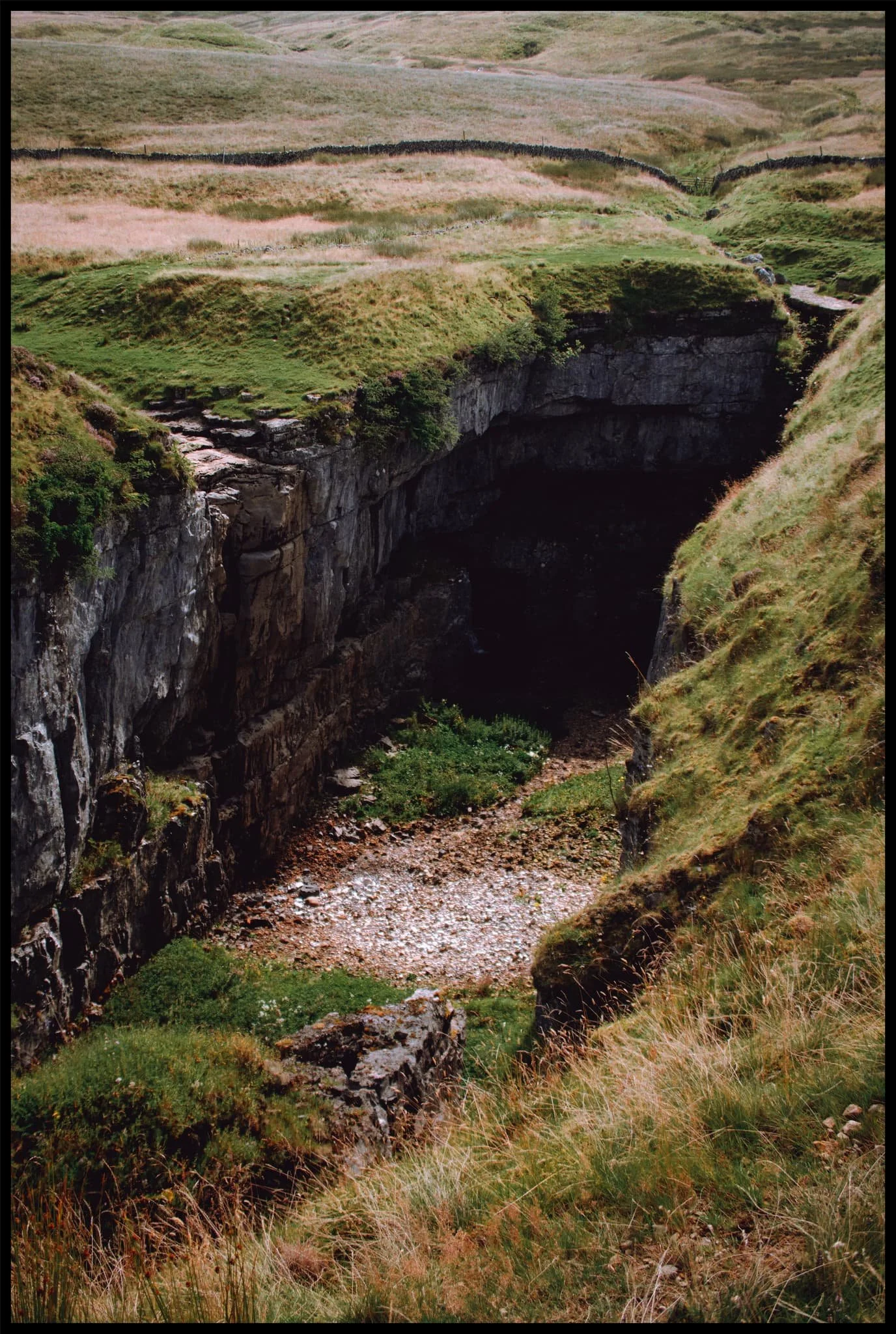  The 50ft+ sheer walls of Hull Pot. In the darkness there is actually a waterfall that rushes out of the caves at the bottom of this chasm. 