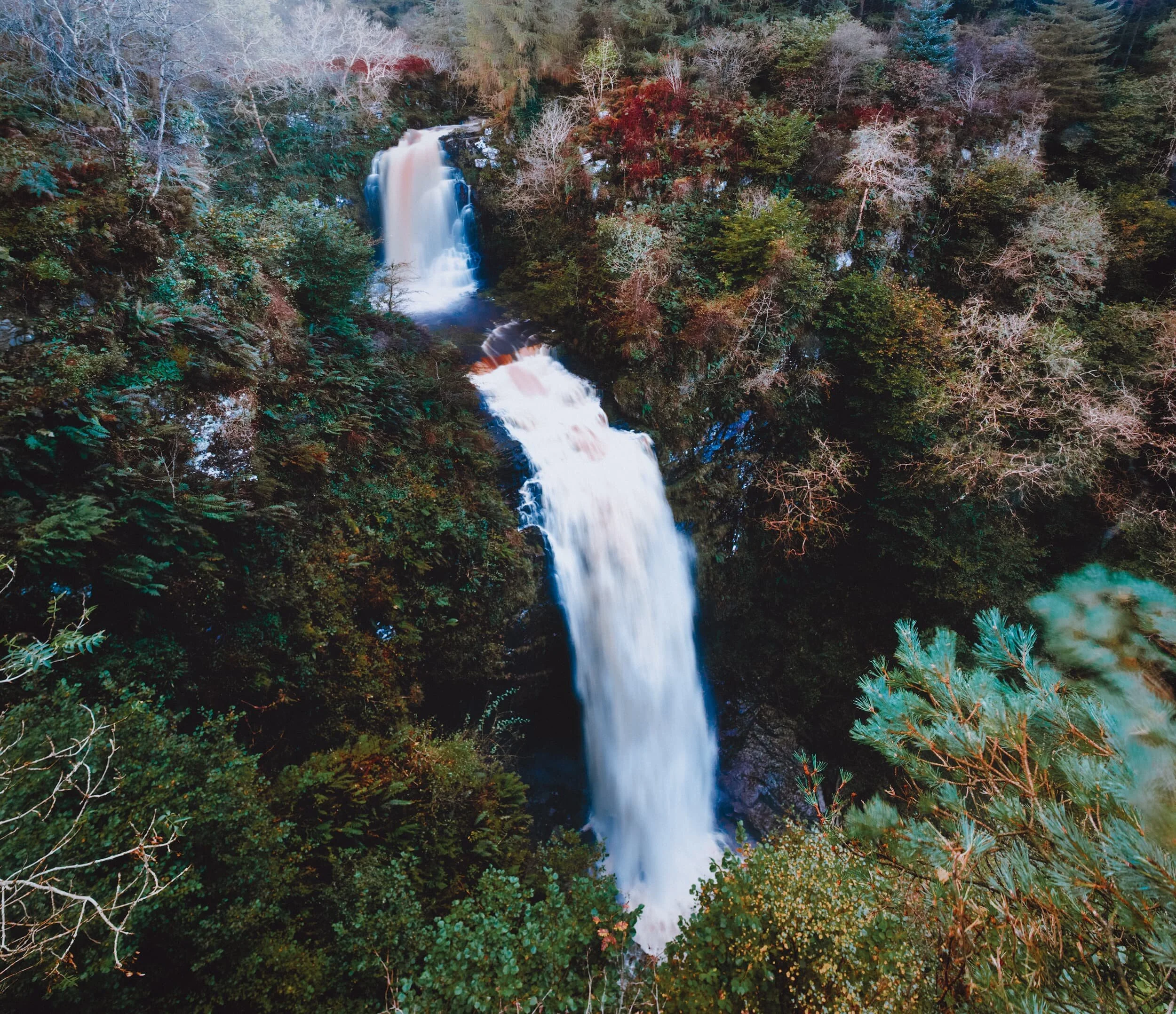  When we ventured back northwards along the southeastern coast of Arran, we stopped at Whiting Bay. There was a walk we knew of that took you to see a rather splendid waterfall. After a fairly strenuous hike, we finally arrived at the viewing point and were absolutely  floored  by the sight of one of the largest British waterfalls I&rsquo;ve ever seen. This is Glenashdale Falls, dropping in two stages by around 140 ft. Even with a 14mm lens, I had to shoot three landscape images and stitch them top to bottom in order to fully show the scale of waterfall. Crazy. 