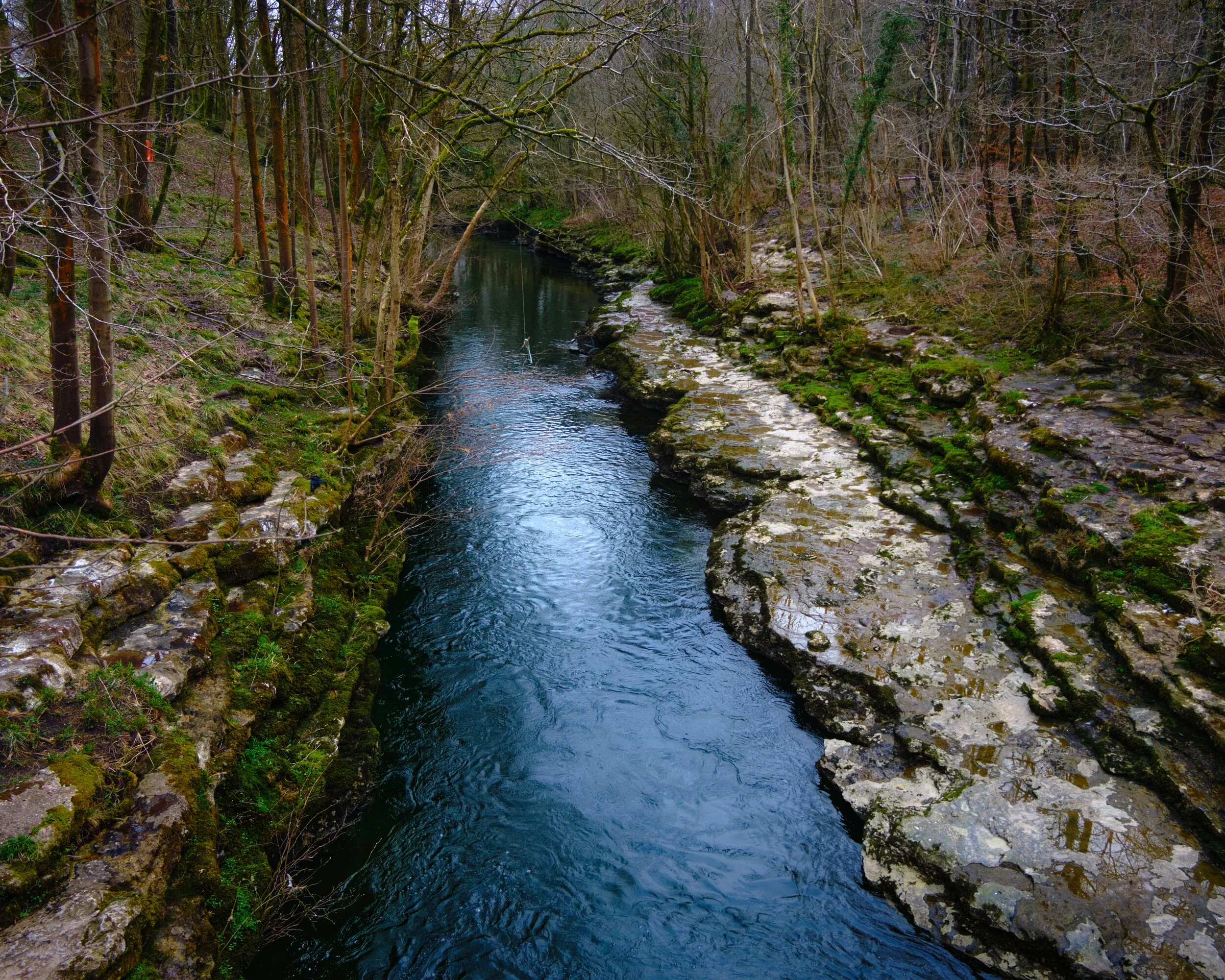 The River Kent from Hawes Bridge. Here the river narrows into a limestone gorge, cutting down deep channels.