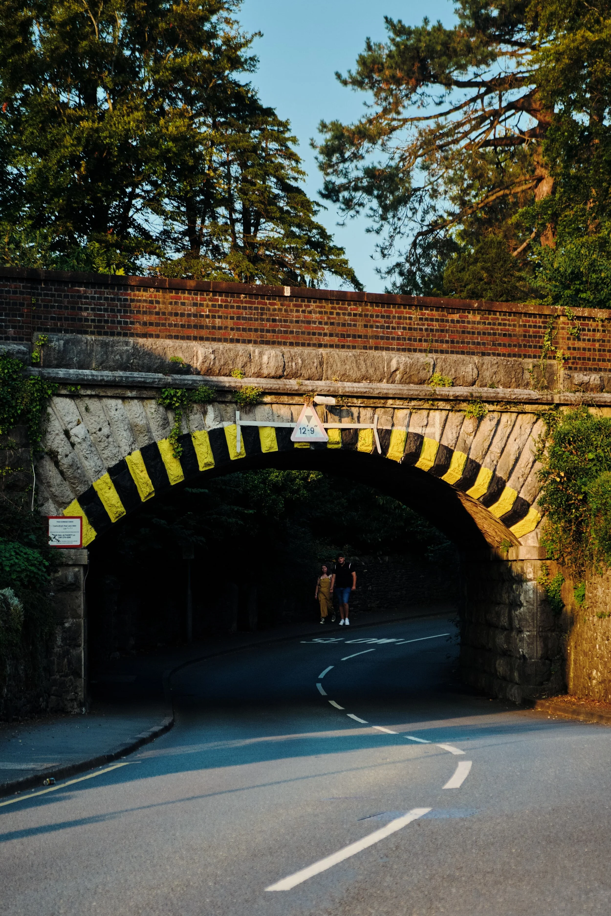 A young couple enjoy a late evening stroll near Sedbergh Road railway bridge. Gorgeous light.