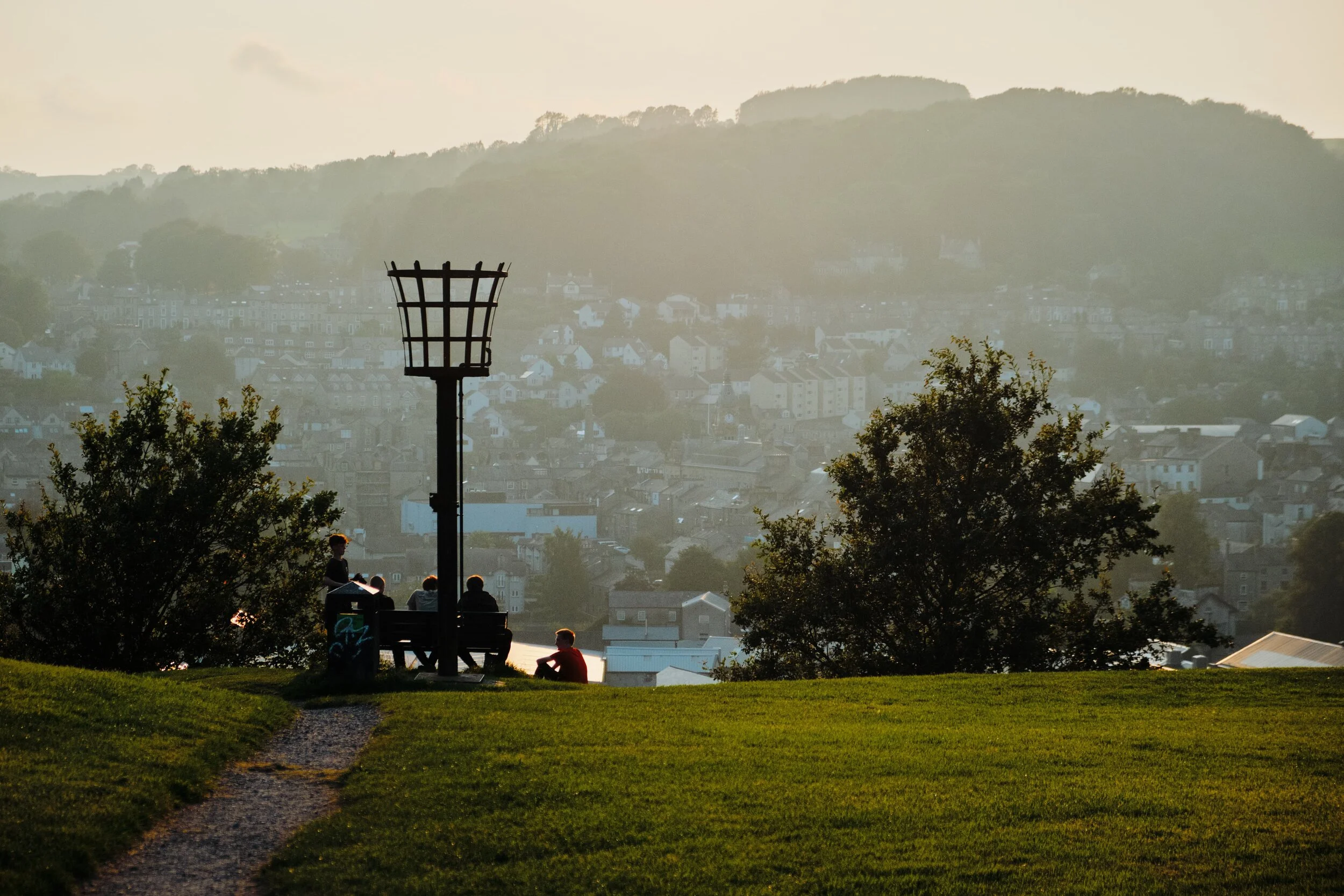 Young friends enjoy the view and setting sun.