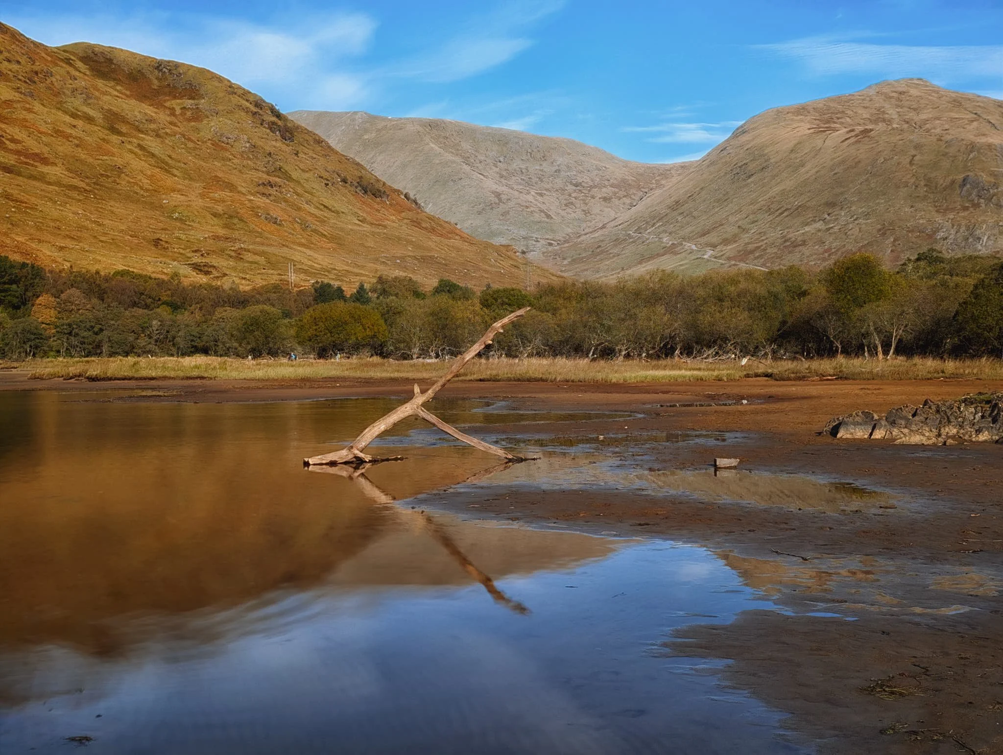  I utilised my Pixel 9 Pro XL&rsquo;s ability to do &ldquo;long exposures&rdquo;* in order to smooth out the water for this composition. A solitary tree branch pointing towards the mountains in the distance: On the right is  Beinn Eunaich  (989 m/3,245 ft), on the left is the shoulder of  Monadh Driseig  (646 m/2,121ft), and rising in the middle  Beinn a&rsquo; Chochuill  (980 m/3,220 ft).  *  In reality, the Pixel is actually shooting a burst of shorter exposures which are then aligned and averaged together. The end result is the same.  