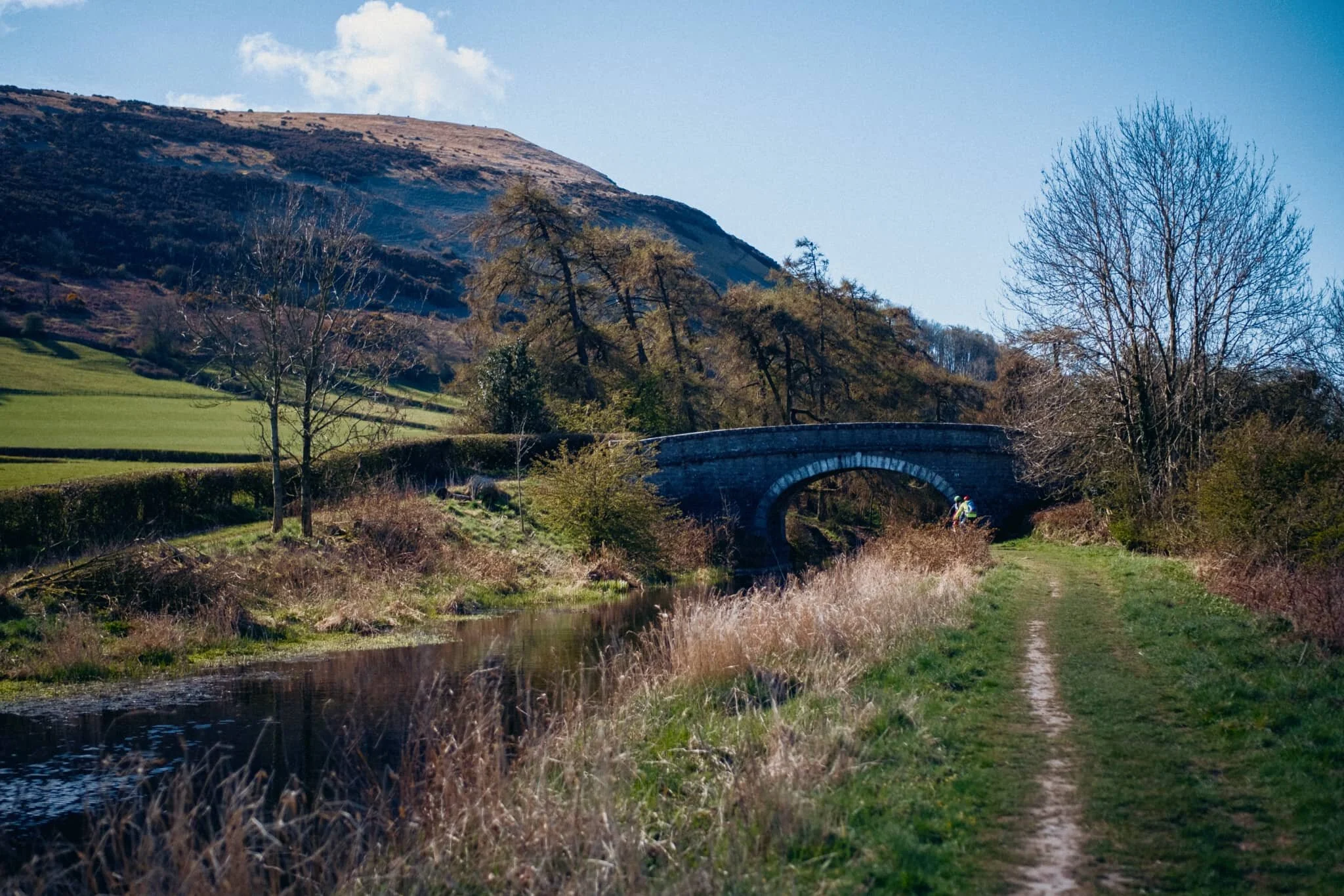 Closer to Duke’s Bridge, with some cyclists ahead enjoying the day.
