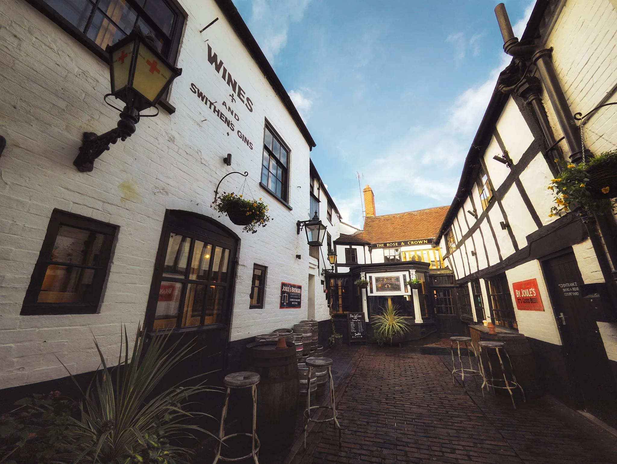  Stashed away down a yard is  The Rose & Crown , proclaiming to be one of Ludlow&rsquo;s oldest pubs, with documents dating back to the 1200s. This courtyard inn as we see it now was built in stages from the 1600s. It still features 1700s brick and timber-frames with sashes and even the rear walls show 1600s timber framing and medieval stone windows. Still in operation as a pub, owned by the Joules Brewery. 