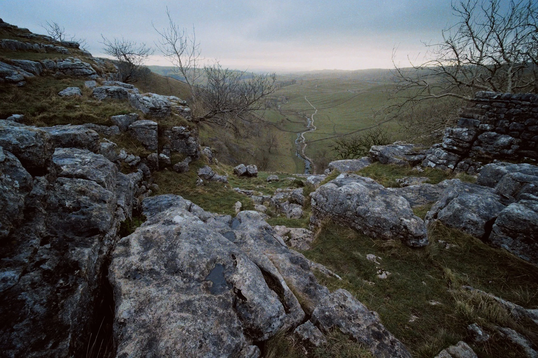 At various points, sudden gaps along the cliff edge opened up, offering views down to Malhamdale. These would’ve been smaller waterfalls that tumbled down Malham Cove, aside from the main one.