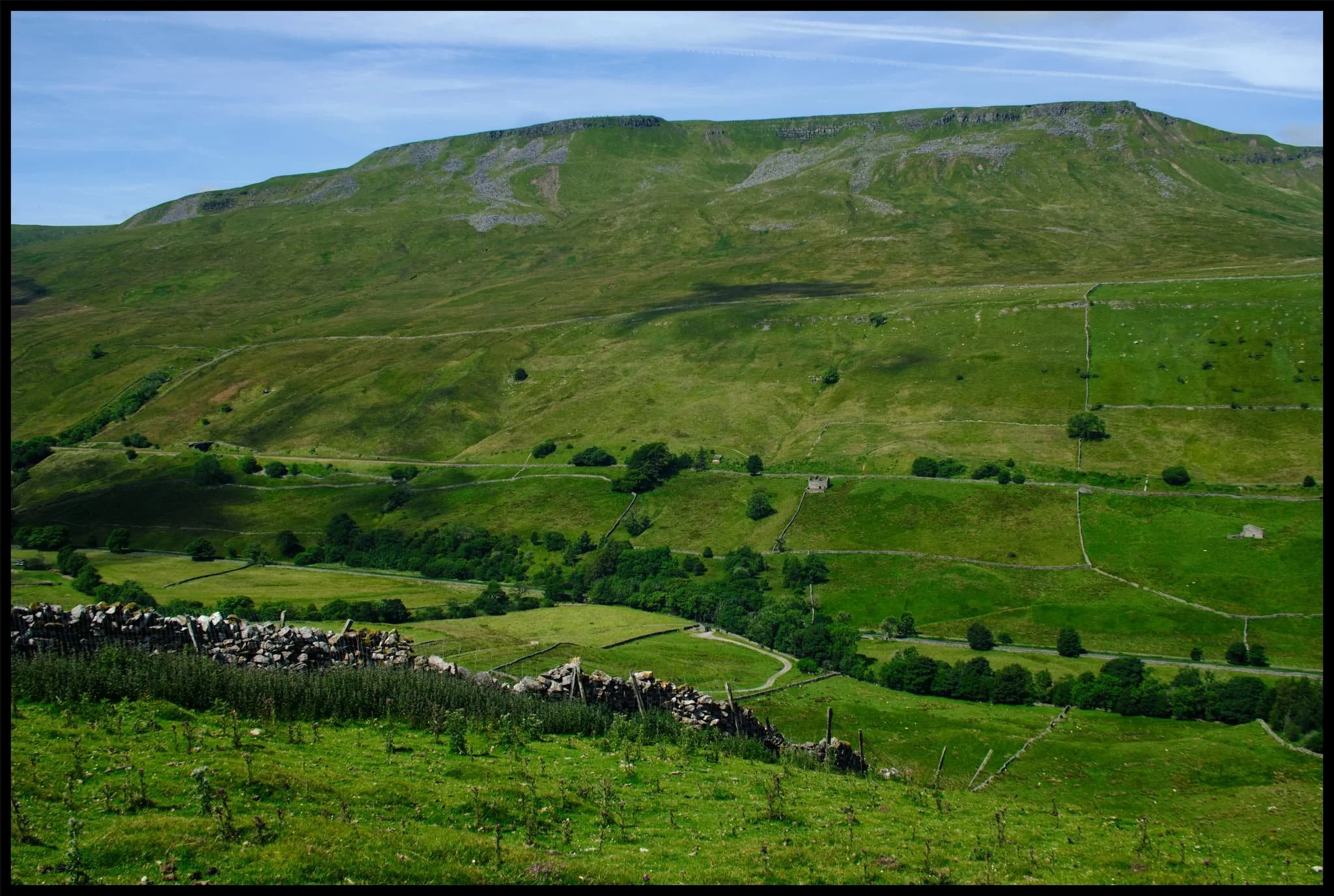  Across the valley, Wild Boar Fell rises steeply into the sky at 2,323 ft (708 m) high. 