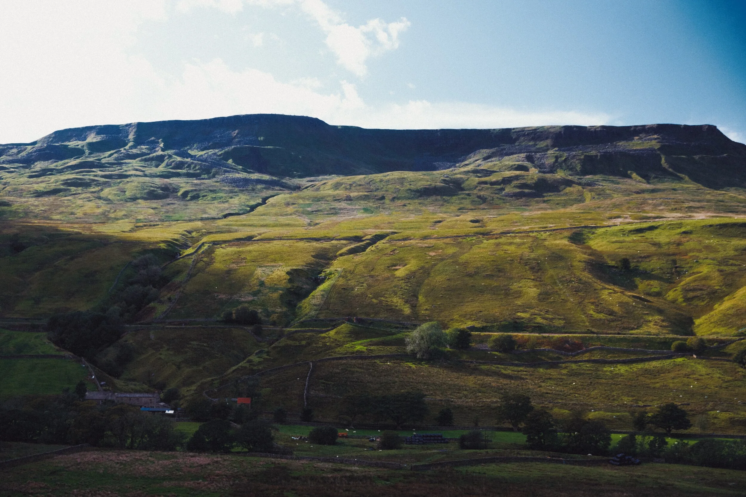Across the valley to the gashes and crags of Wild Boar Fell, with High White Scar on the left and The Nab on the right, both towering above Aisgill Farm.