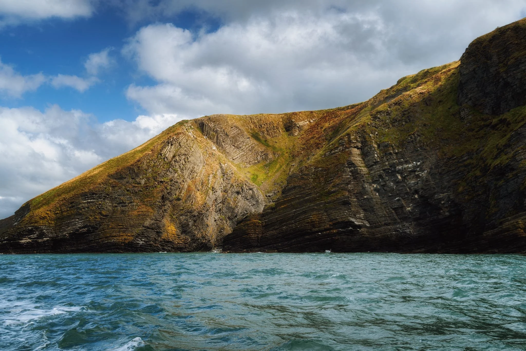  Look at those layers of rock; millions of years of history, laid on top of each other like pages in a book. Further geology processes have compressed, folded, and intruded into these layers, then eroded away by the sea, leaving these incredible scenes. 