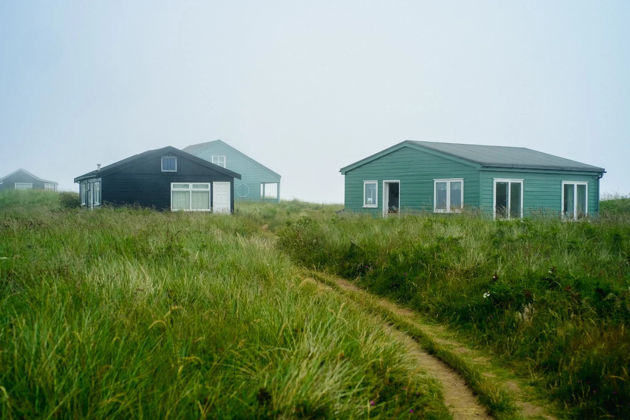 Above Embleton Bay, near the Embleton Links golf course, there’s a whole bunch of “beach chalets” or, more accurately, bungalows that sit on National Trust land. On a clear sunny day I’ve no doubt they look adorable and inviting. With the sea fret rolled in, the bungalows presented a more foreboding presence.