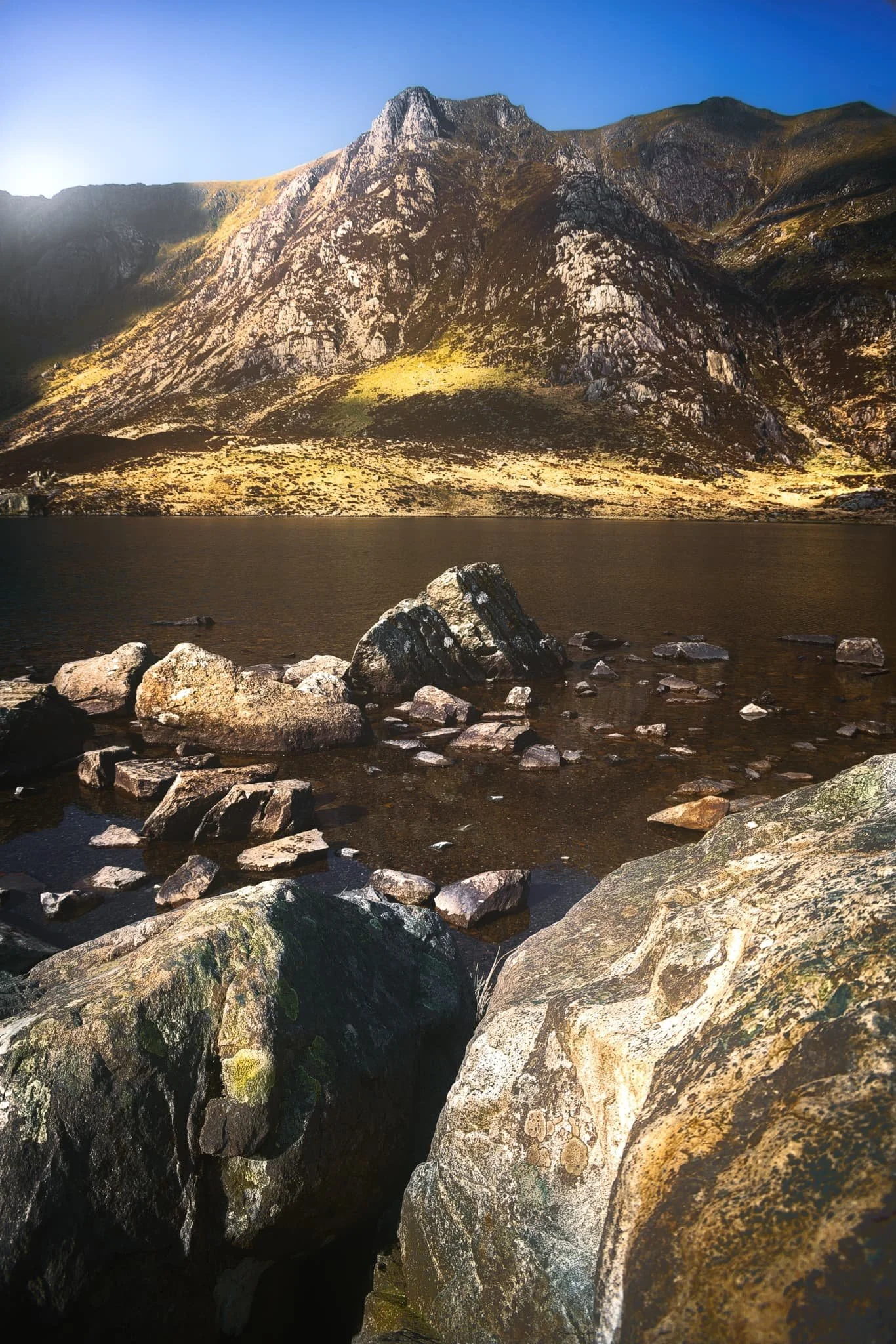  Beyond Tryfan, we climbed up the trail to take the Cwm Idwal circuit. I were very much hoping the light and conditions to be right enough so that the rising sun would illuminate the Idwal Slabs high above the tarn. Here,  Castell y Geifr  catches the rising sun above Cwm Idwal. 