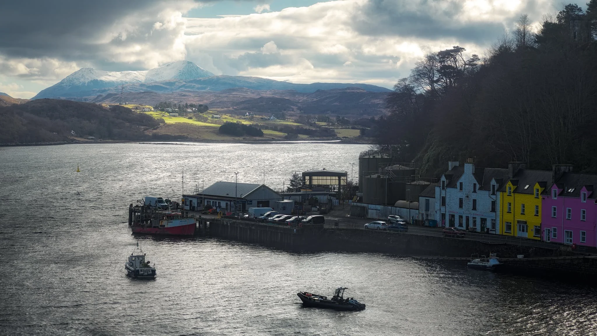  Back at Portree the light continued to change dramatically, with the clouds lifting above the Cuillins. I zoom in tight on this composition of Portree harbour as the light broke through the clouds enough to highlight the snowy Cuillins. 