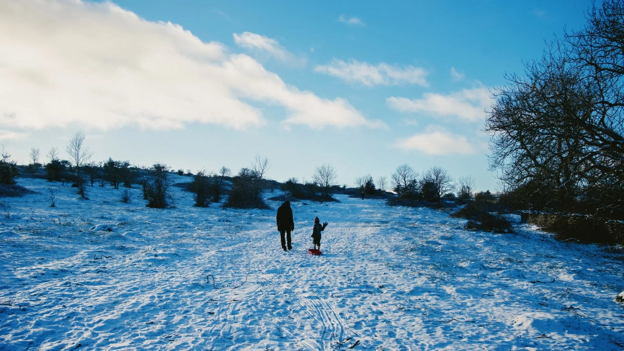 It wasn&rsquo;t long until we came across our first sledging family, excitedly pulling their sledge back up the fell side for another ride. 