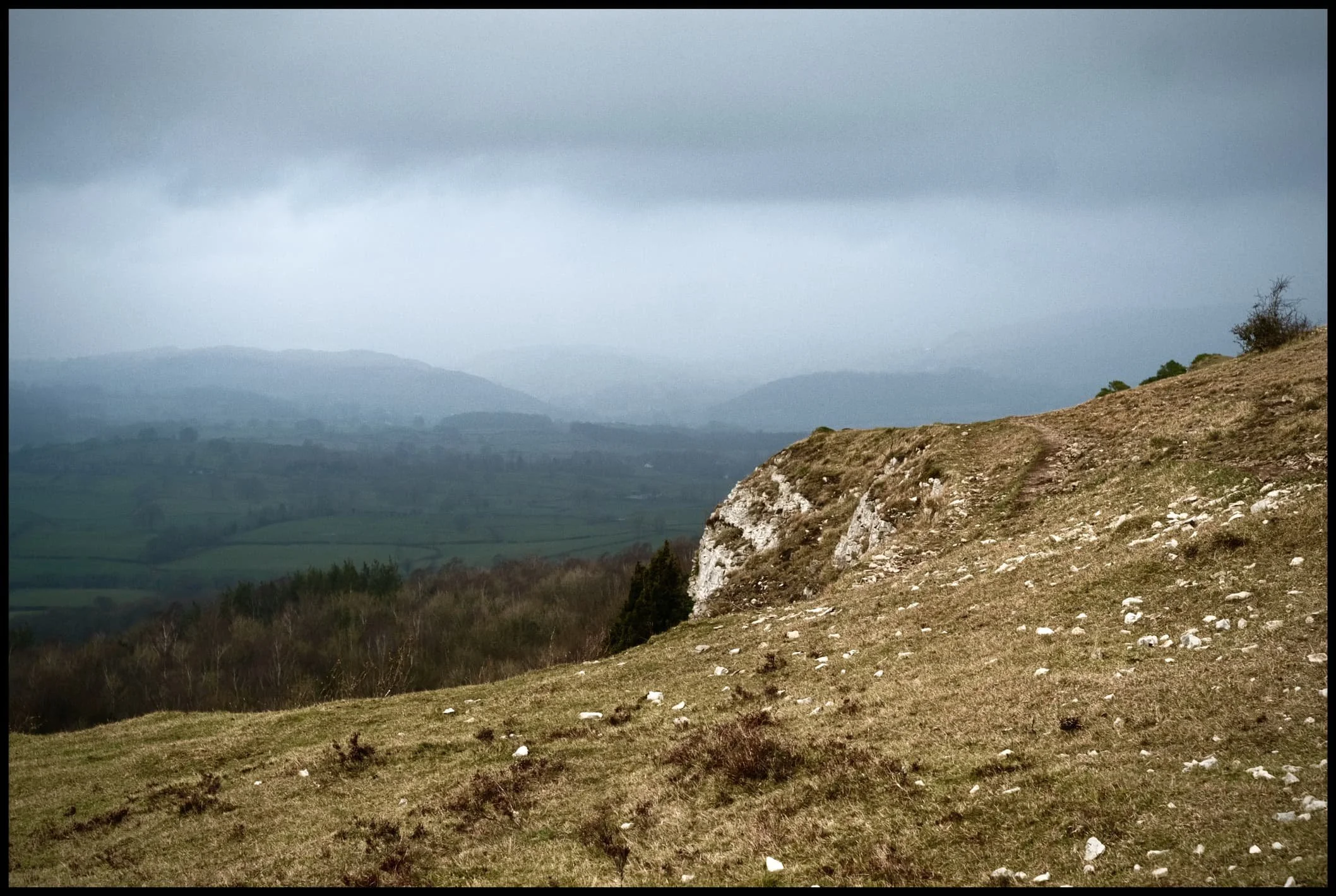  The sun catches the cliffs of Scout Scar briefly, whilst the Lyth Valley and the the Lakeland Fells remain shrouded in dark foreboding clouds. 