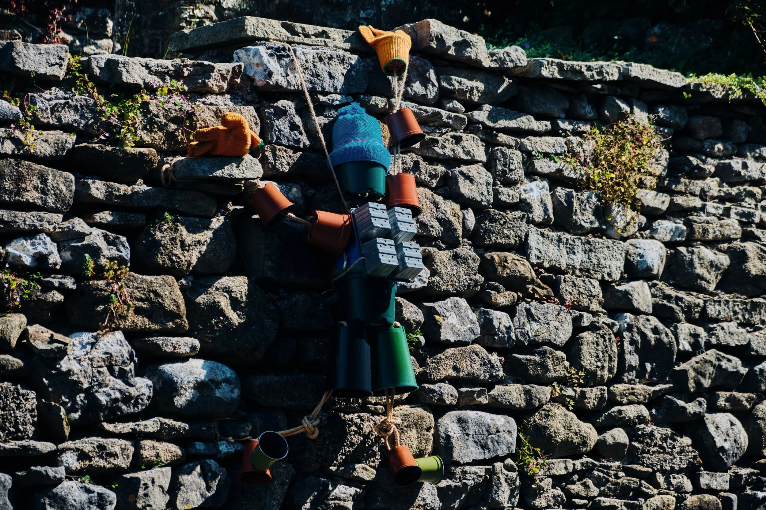 In August and September Settle is home to the Settle Flowerpot Festival (seriously), where local residents create all kinds of monuments, statues, and amusing scenarios using flowerpots. Here, a mountain climber scales the wall.
