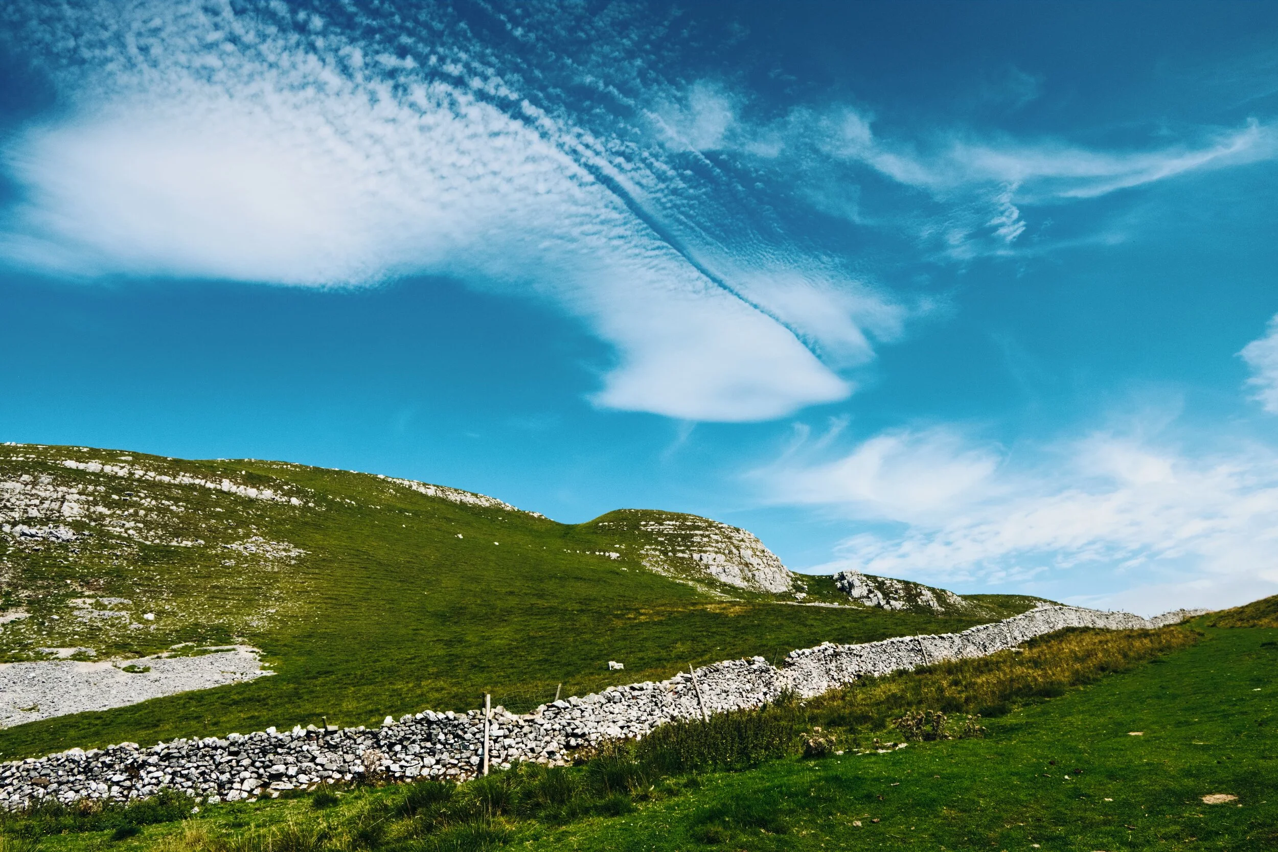 As we started our descent west of Attermire Scar and Warrendale Knotts, towards Settle, I looked back and saw this high-altitude wispy cloud seemingly split in half. Created by an aeroplane of some sort?