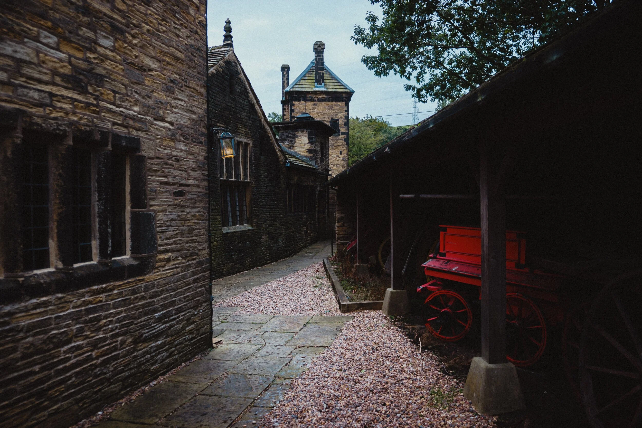Around the back of the Brew House, with old carriages.