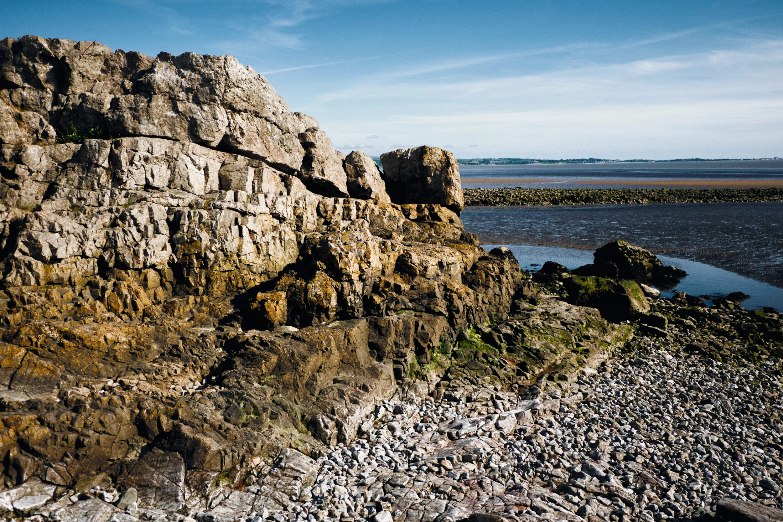 This is a delightful little limestone cove that leads out to the expansive sea and sands of Morecambe Bay below an area called Jack Scout. Far across Morecambe Bay in the distance is Morecambe itself and Heysham.