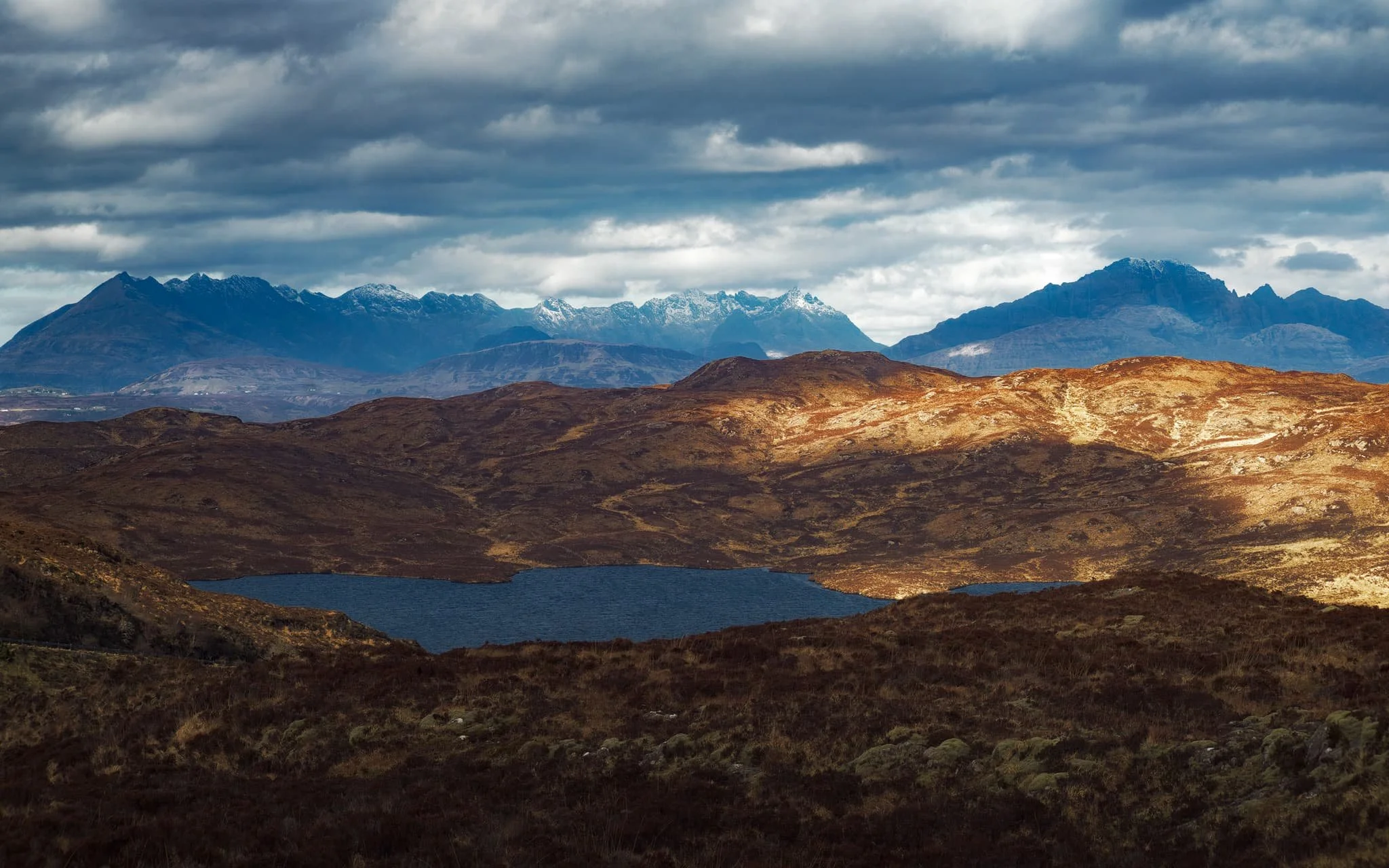  From near Armadale you can take the single-track winding road over the Sleat peninsula towards its northern shores. Along the way, though, magnificent views of the Cuillins reveal themselves. We stopped to nab some photos from above Loch Dhùghaill because who can say no to this?! 