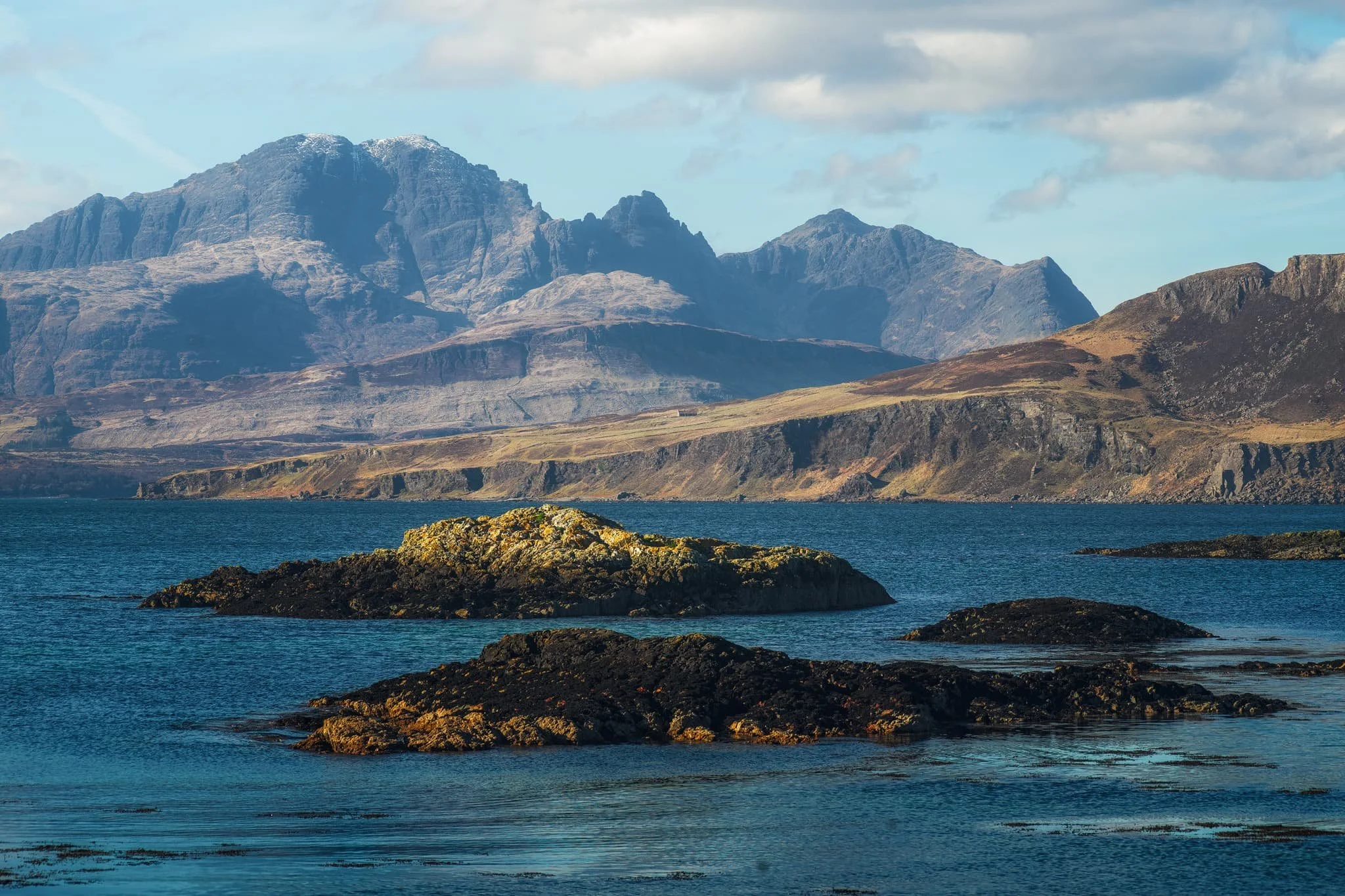 From Ord I once again equipped my 70-210mm zoom lens for some tighter compressed compositions. I lined up the small rocky islands just off the bay to lead towards the Strathaird coastline and  Blàbheinn  looming above everything. 