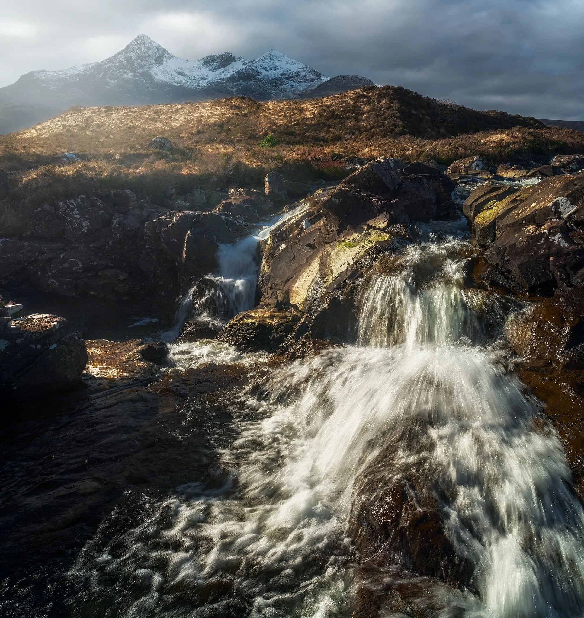  A 3-shot 28mm panorama stack from top to bottom enabled this composition of another waterfall with the snowy Black Cuillins darkening above. 