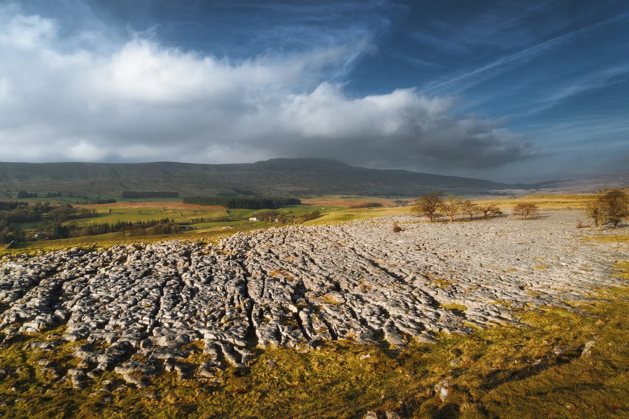  We clambered up onto the next plateau and a drone-esque composition reveals itself to us. The full expanse of this part of Southerscales Scar becomes apparent, with Whernside—the Dales&rsquo; tallest peak—rising up and tussling with the clouds. The Yorkshire Dales, in all its rugged beauty. 