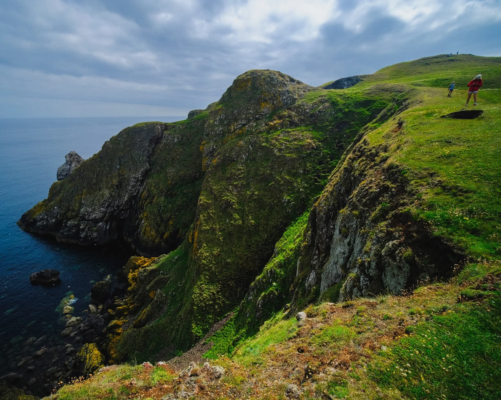  Other hikers follow the cliff edge trail, and as I line up a composition of the cliffs of St. Abb&rsquo;s Head, I deliberately include the people to help provide a sense of scale. 