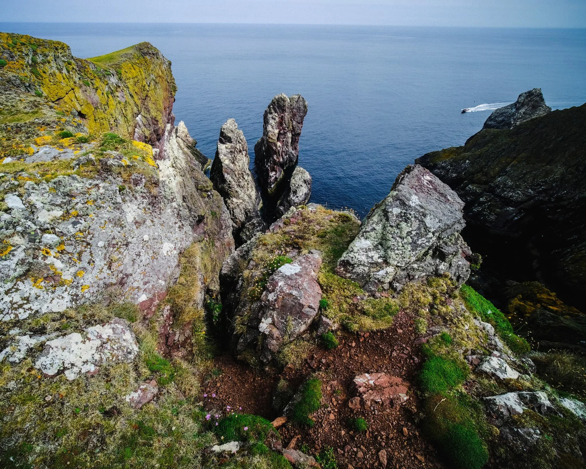  With my ultra-wide 9mm lens, I was able to capture images looking almost vertically down to the sea from the cliff edges  as well as  the horizon. A scene of pure drama, with sheer cliffs and finned sea stacks covered in guano. 