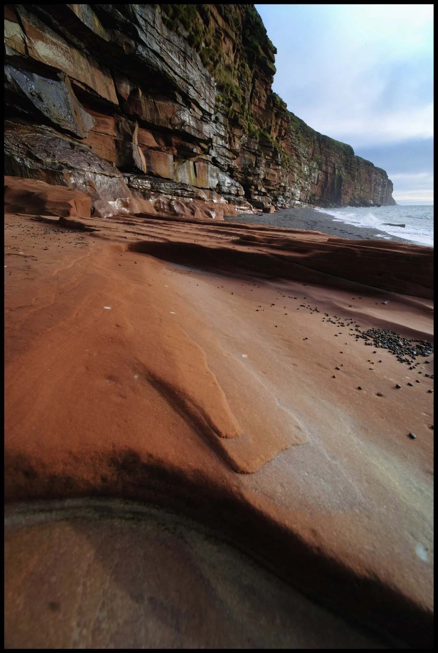  Millennia of wave action have torn chunks off the cliff face, and smoothed out boulders. 