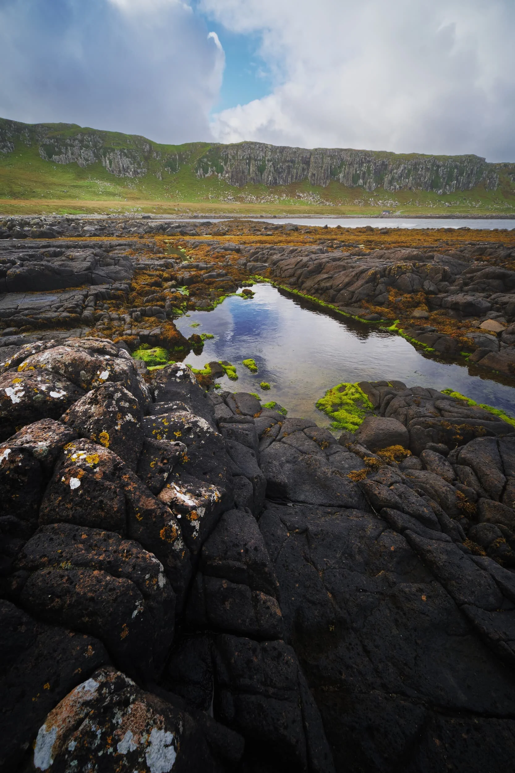 A simple composition showing off the tetris-like structure of the raised rock bed at Breun Phort , looking back towards the 50 ft cliffs that dominate the An Corran coast.