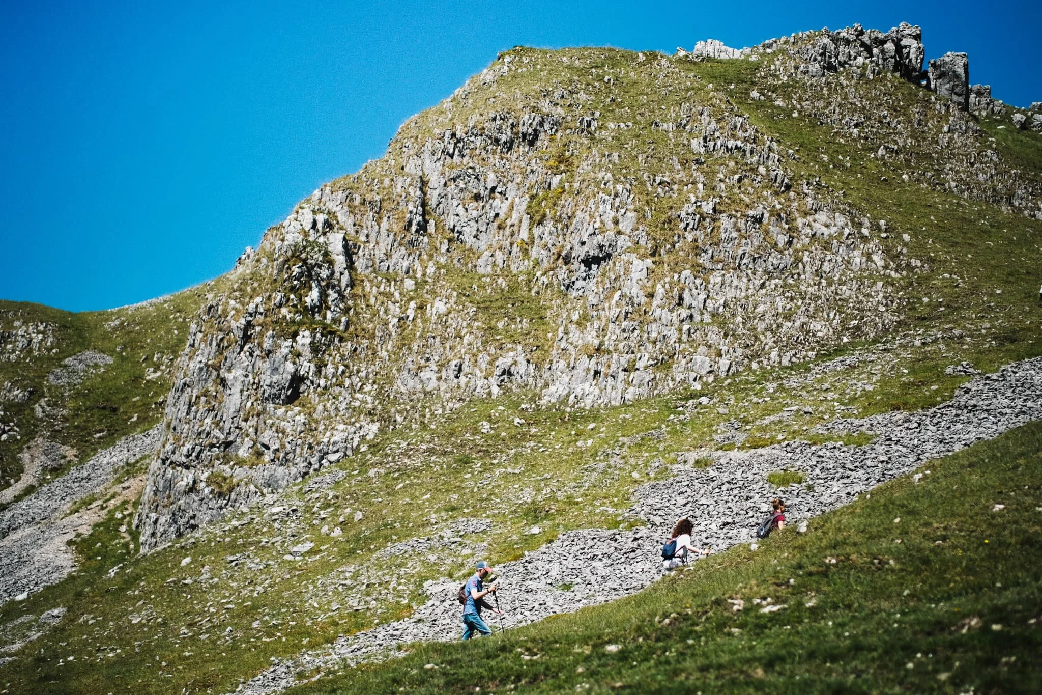 The east face of Warrendale Knotts, with some hikers ascending up the channel between this fell and Attermire Scar.