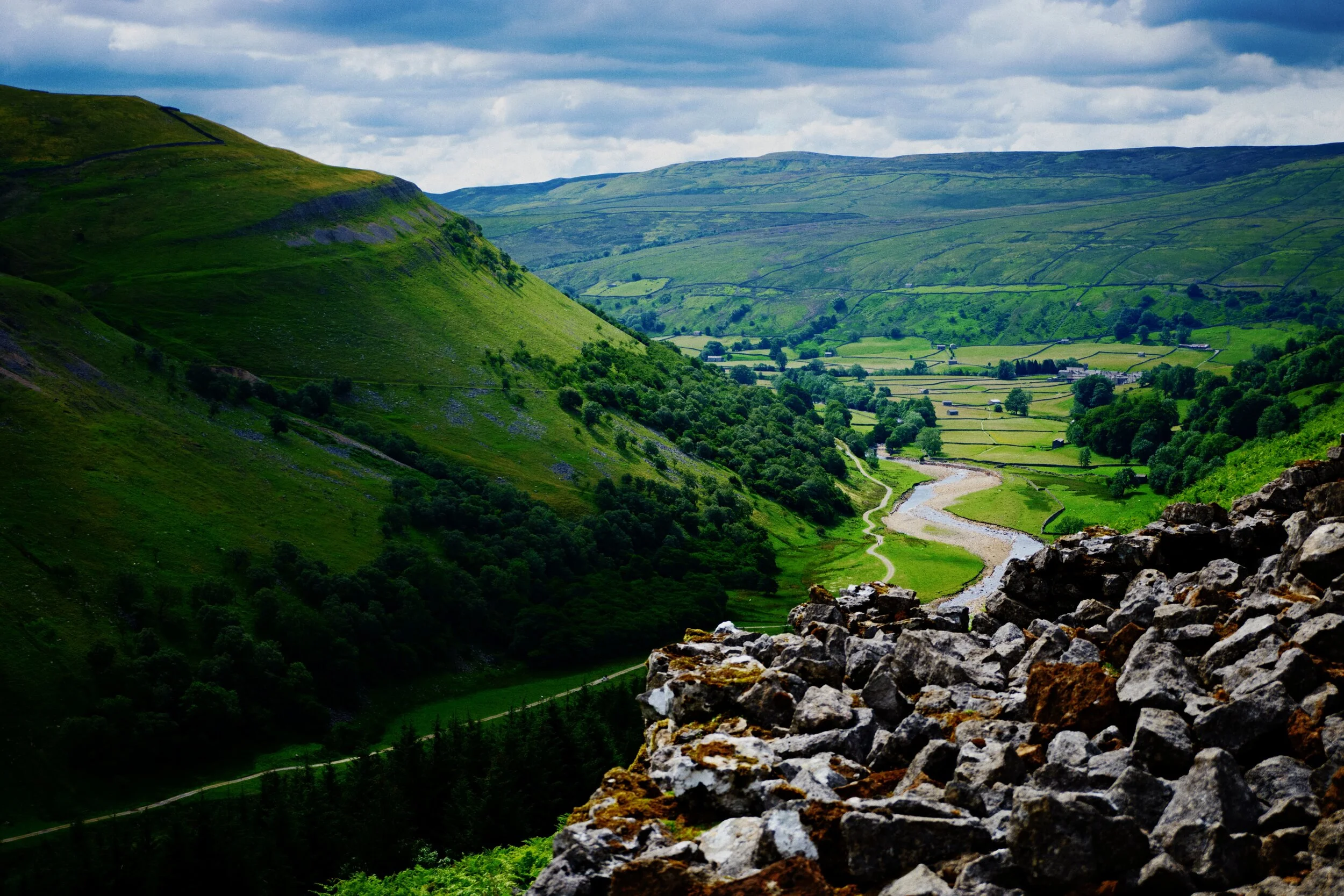 The summer sun gets filtered through the clouds, with the resulting soft light gradually rolling over the fellside of Arn Gill Scar and down into the valley bottom.