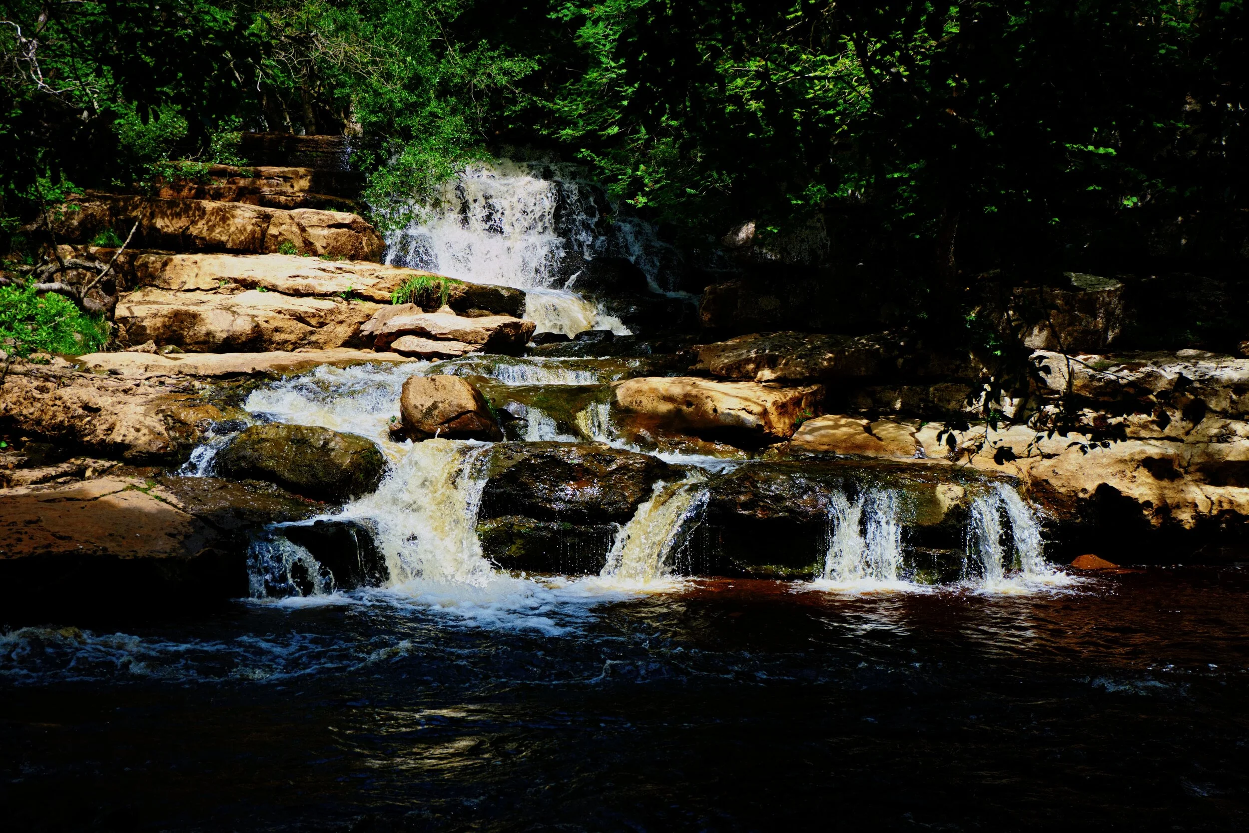 The bottom of Catrake Force where it joins the River Swale into a deep gorge.