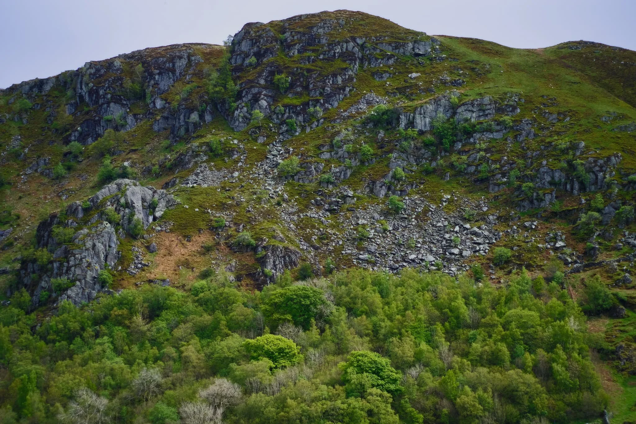 The crag of Ewe Close, catching a little bit of the light that was emerging from the thinning clouds.