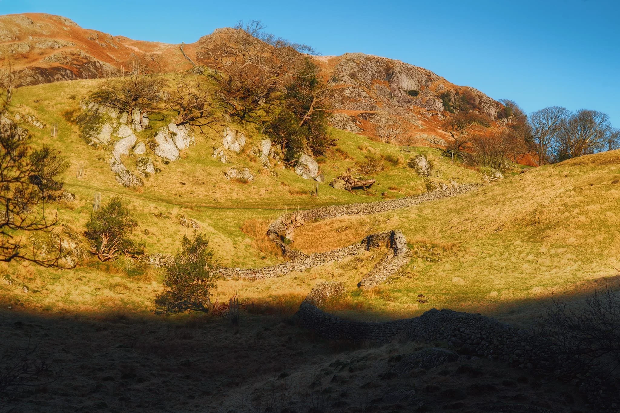 The shadow cast by Knotts gradually creeping its way towards Lingmoor Fell’s shoulder.
