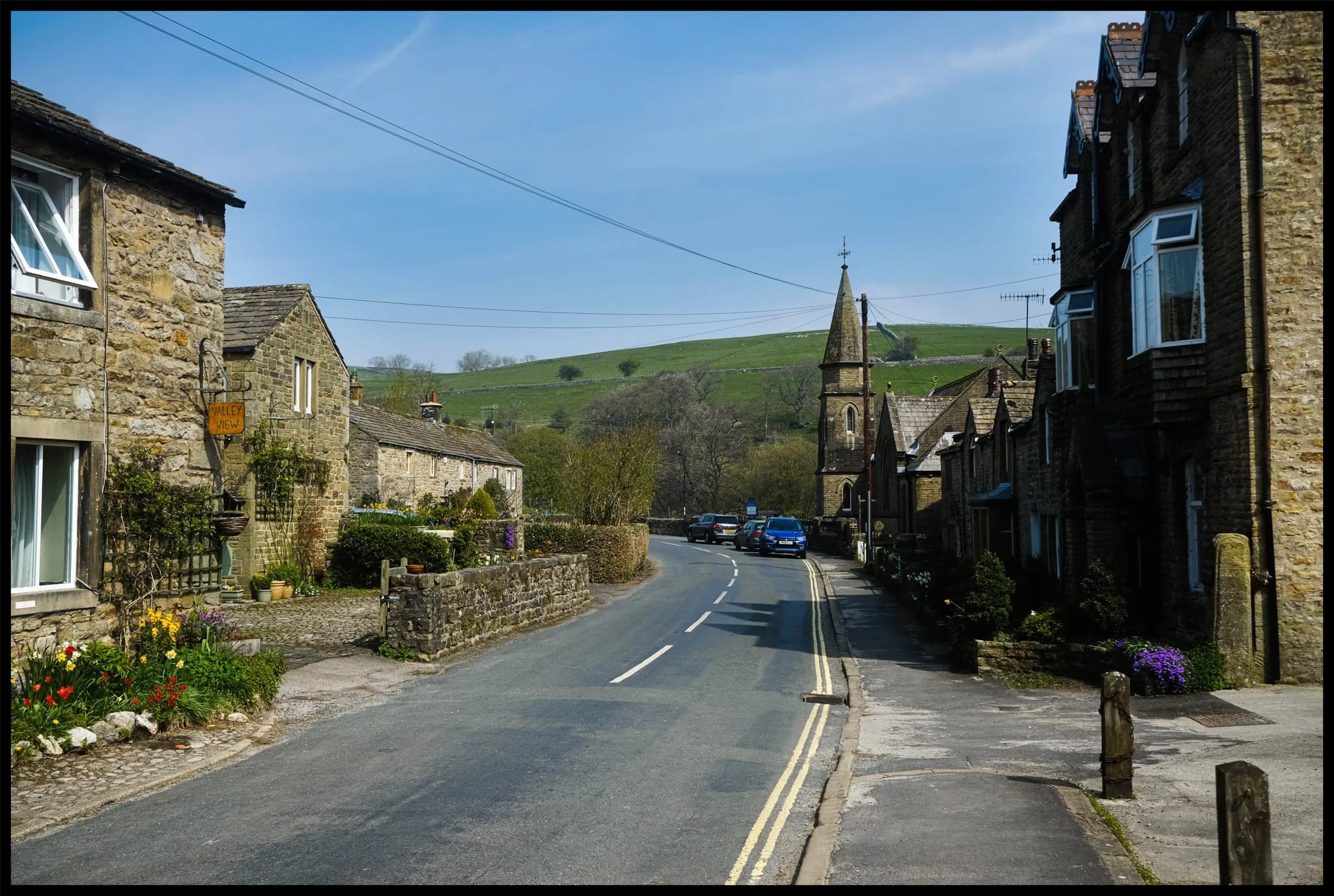  Like many Yorkshire Dales villages, there&rsquo;s plenty of historical sandy limestone buildings decorated with beautiful greenery, flowers, and the distant hills. 